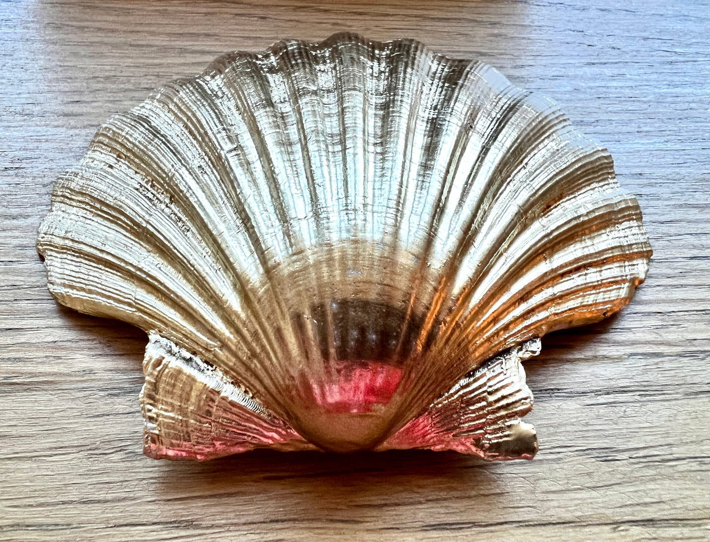 Handcrafted William Morris Golden Lily scallop shell ring holder featuring an elegant botanical floral pattern in green, cream and muted red tones. Decorative Dorset shell trinket dish finished with hand-painted gold leaf edging and sealed in glossy crystal resin for a luxurious shine. Coastal inspired jewellery tray and bedside catchall perfect for rings, earrings and keepsakes. Botanical shell decor for elegant interiors, cottage style homes, thoughtful handmade gifting.