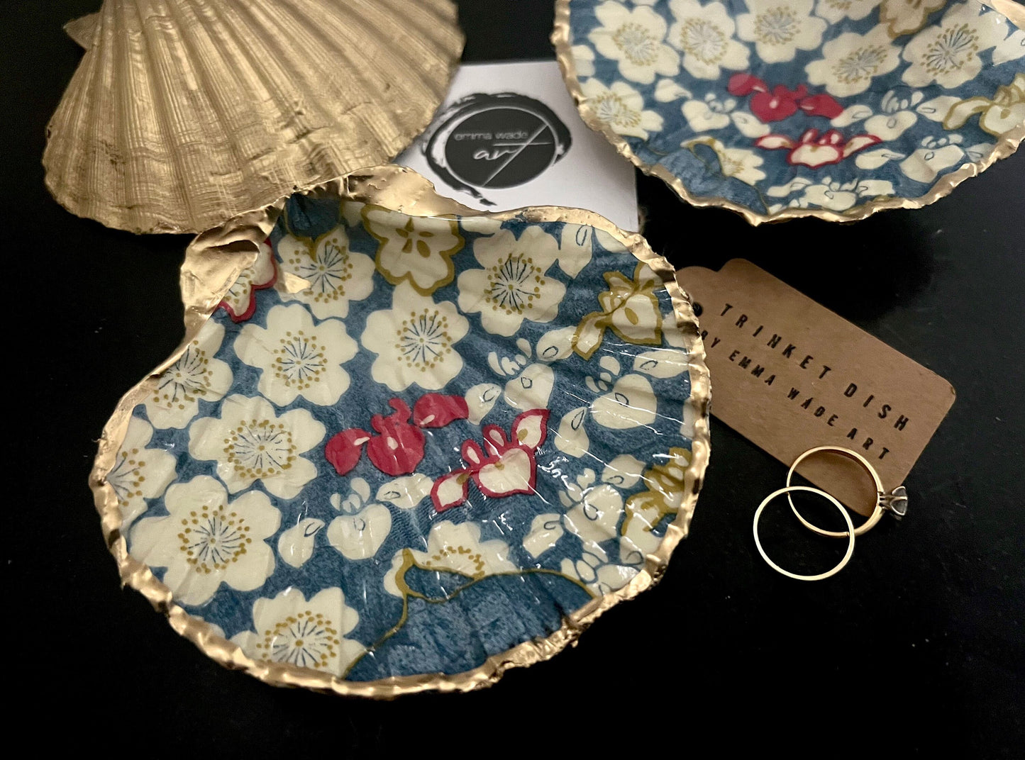 Japanese Sakura cherry blossom floral scallop shell trinket dish with blue, cream and red botanical flower design, hand finished with liquid gold leaf edging and glossy resin. Handmade coastal jewellery tray and ring dish inspired by Japanese floral art and Dorset coastal décor.