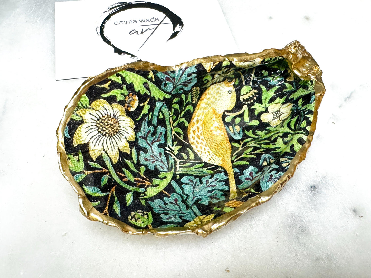 Handcrafted William Morris Strawberry Thief oyster shell dish. Gilded with real gold leaf and finished with glossy resin. Two designs available. Ideal as a jewellery dish, trinket holder, cufflink or tie pin dish, tea light holder, or salt and pepper pinch pot. Sustainable coastal décor, UK handmade shell ornament, unique gift for weddings, birthdays, anniversaries, or Christmas.