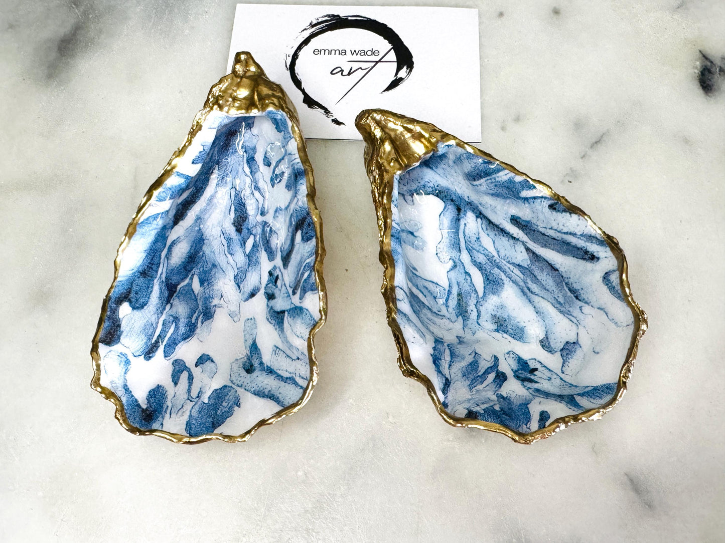 Handcrafted Dorset oyster shell trinket dish featuring blue seaweed design | Gilded with liquid gold leaf and sealed with clear resin | Perfect as a jewellery dish, ring holder, or decorative coastal ornament | Optional gold antler stand available | Each shell is sustainably sourced and hand finished with unique natural variations | Ideal ocean-inspired gift for weddings, anniversaries, birthdays, or home decor