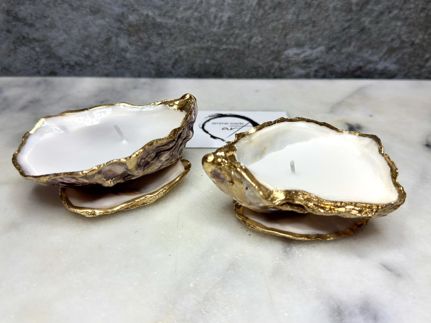 oyster shell candle, gold oyster candle, gilded oyster shells, hand poured candle, coastal decor, ocean inspired candle, beach home decor, sustainable candle, handmade in Surrey, luxury shell candle, sea lover gift, oyster shell pair, artisan candle, eco friendly candle, gold rim shell, nautical decor, ocean gift, coastal homeware, handmade oyster shell candle, shell wedding decor, seaside candle, mother of pearl shell, gold edged candle, beach cottage style, elegant coastal gift