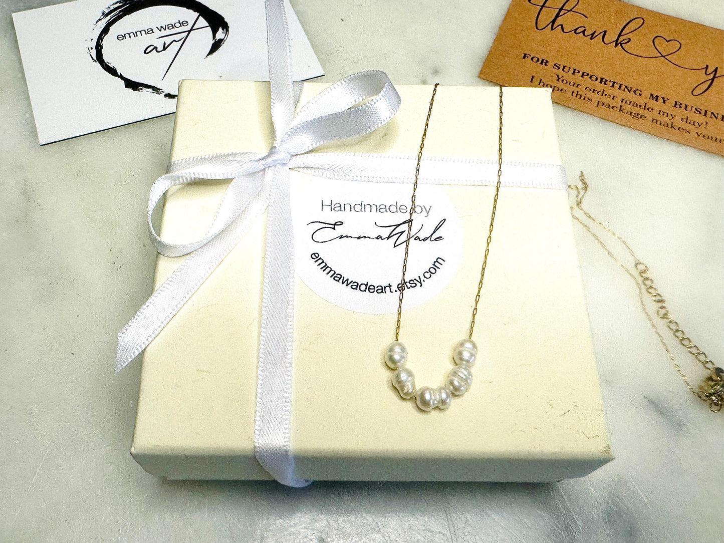 Handmade gold gilded cockle shell jewellery box with pearly white interior and optional freshwater pearl necklace. Coastal shell ring box crafted from natural Dorset shells, edged with liquid gold leaf and presented in a luxury gift box. Elegant seaside-inspired keepsake gift for weddings, bridesmaids, birthdays, anniversaries, or jewellery storage.