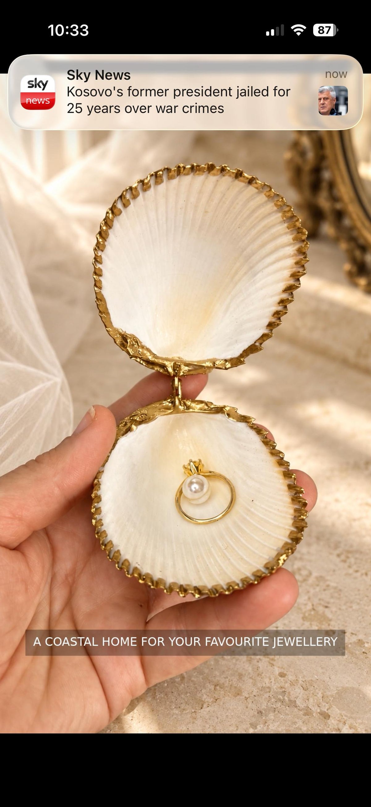 Handmade hinged cockle shell ring box with a natural white ridged interior and hand-finished gold-leaf edging. Available with a natural or gold-leaf outer shell, a natural or gold-speckled interior, and with no pearl or one pearl ring stop. A coastal jewellery box for storing rings and small treasured pieces.