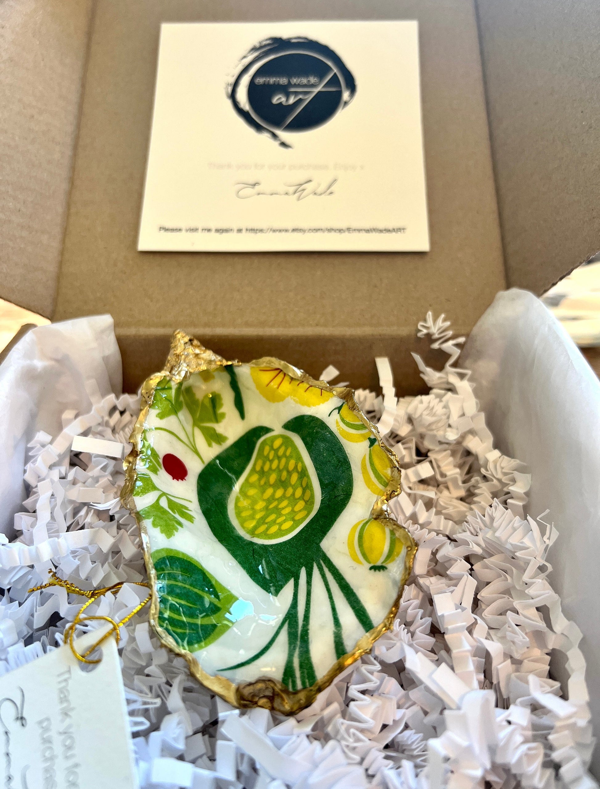 Handmade Dorset oyster shell trinket dish featuring colourful garden fruit artwork in green, yellow, and red tones with hand-gilded gold leaf edging and glossy resin finish. Coastal jewellery holder and botanical home décor gift.