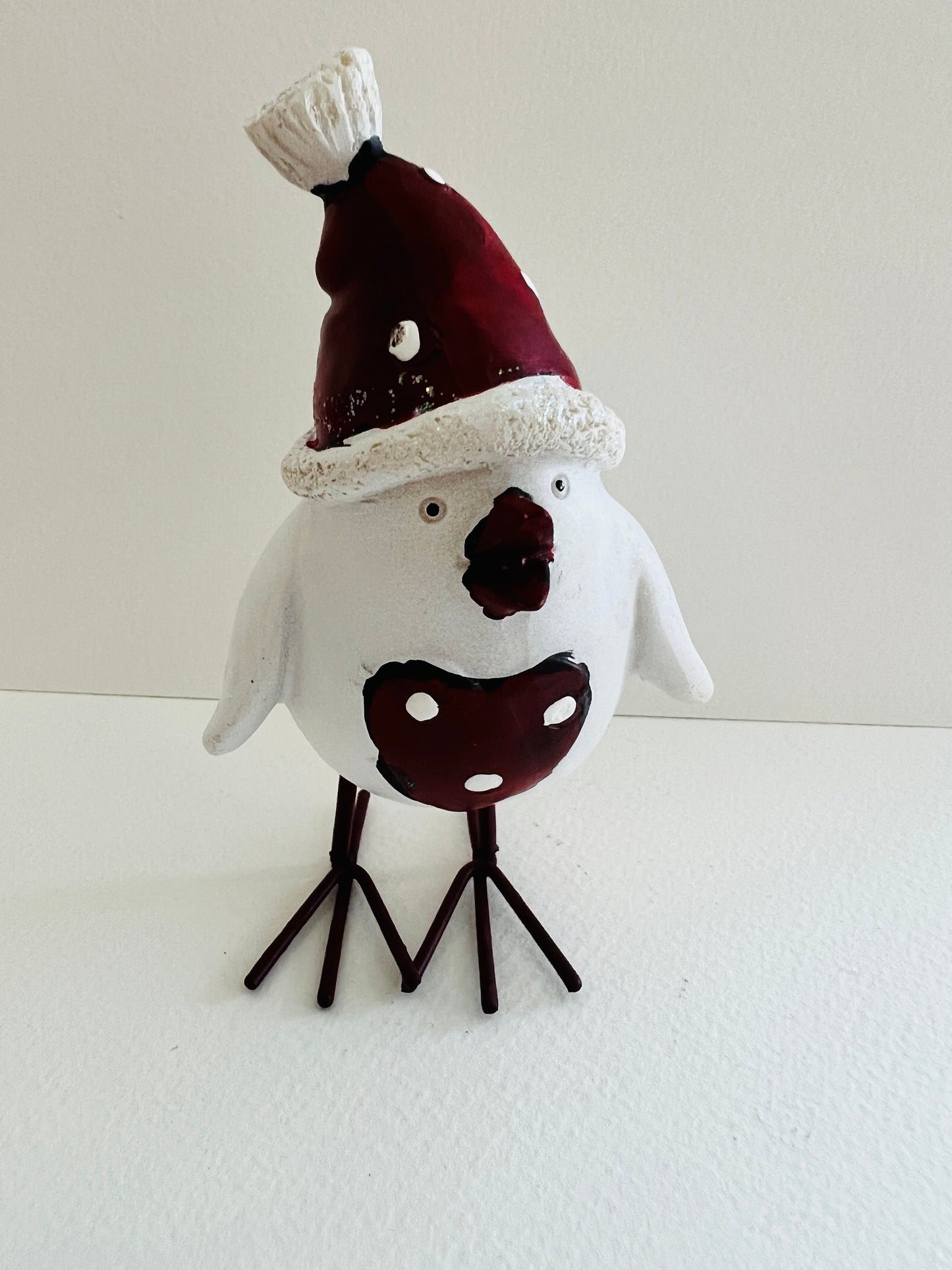 Set of three hand finished robin Christmas ornaments with festive hats, scarves and red heart details. Rustic woodland style bird decorations in cream, burgundy and red tones, perfect for Christmas tree décor, festive styling and stocking filler gifts.