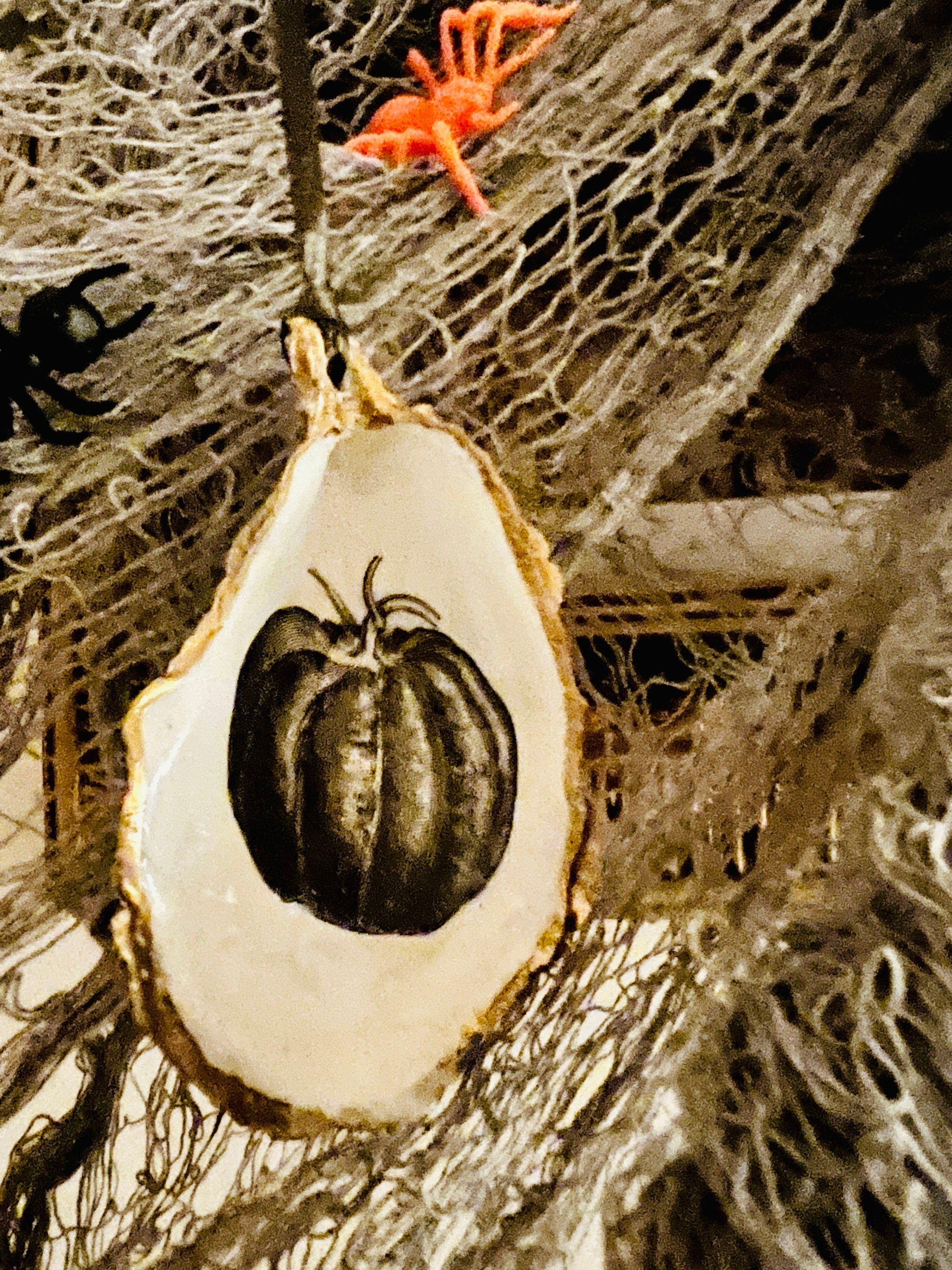 gothic ornaments, halloween oyster shell, gilded oyster hanging ornaments, coastal gothic decor, gothic christmas ornament, skull oyster shell decoration, pumpkin oyster shell ornament, raven oyster shell hanging decor, spooky oyster shell trinket dish, gothic halloween tree ornament, handmade gothic oyster shell gift, oyster shell gothic home accessory, dark gothic oyster shell decor, halloween oyster shell candy dish, gothic oyster shell jewellery holder, handmade oyster art UK