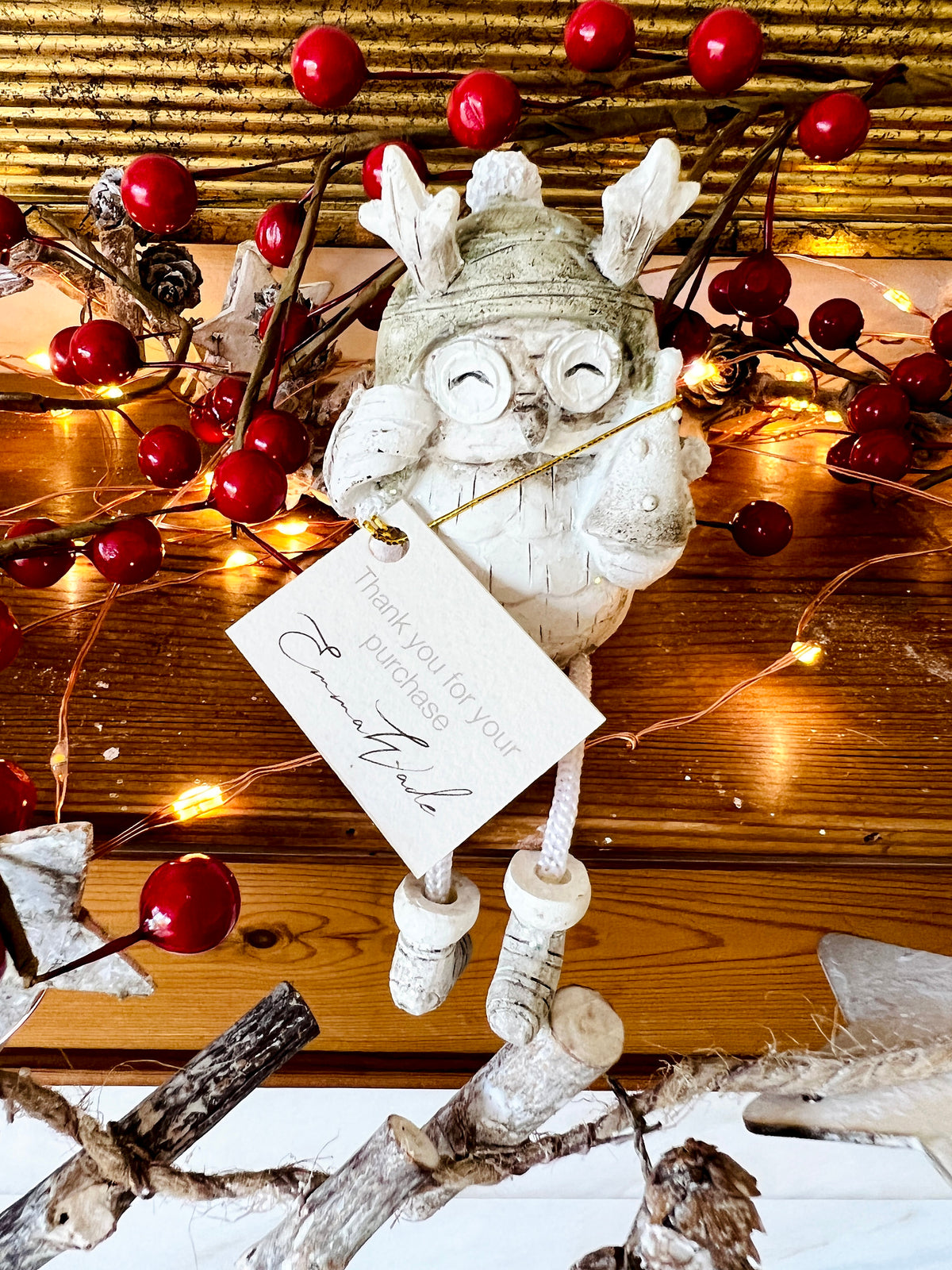Set of three woodland Christmas owl shelf sitter decorations in soft white, grey and natural tones, featuring winter hats, scarves and festive details. Moulded resin owl ornaments with subtle glitter accents and dangling cord legs with little boots, designed to sit on a shelf, mantelpiece or windowsill. Festive woodland Christmas décor and owl lover gift.