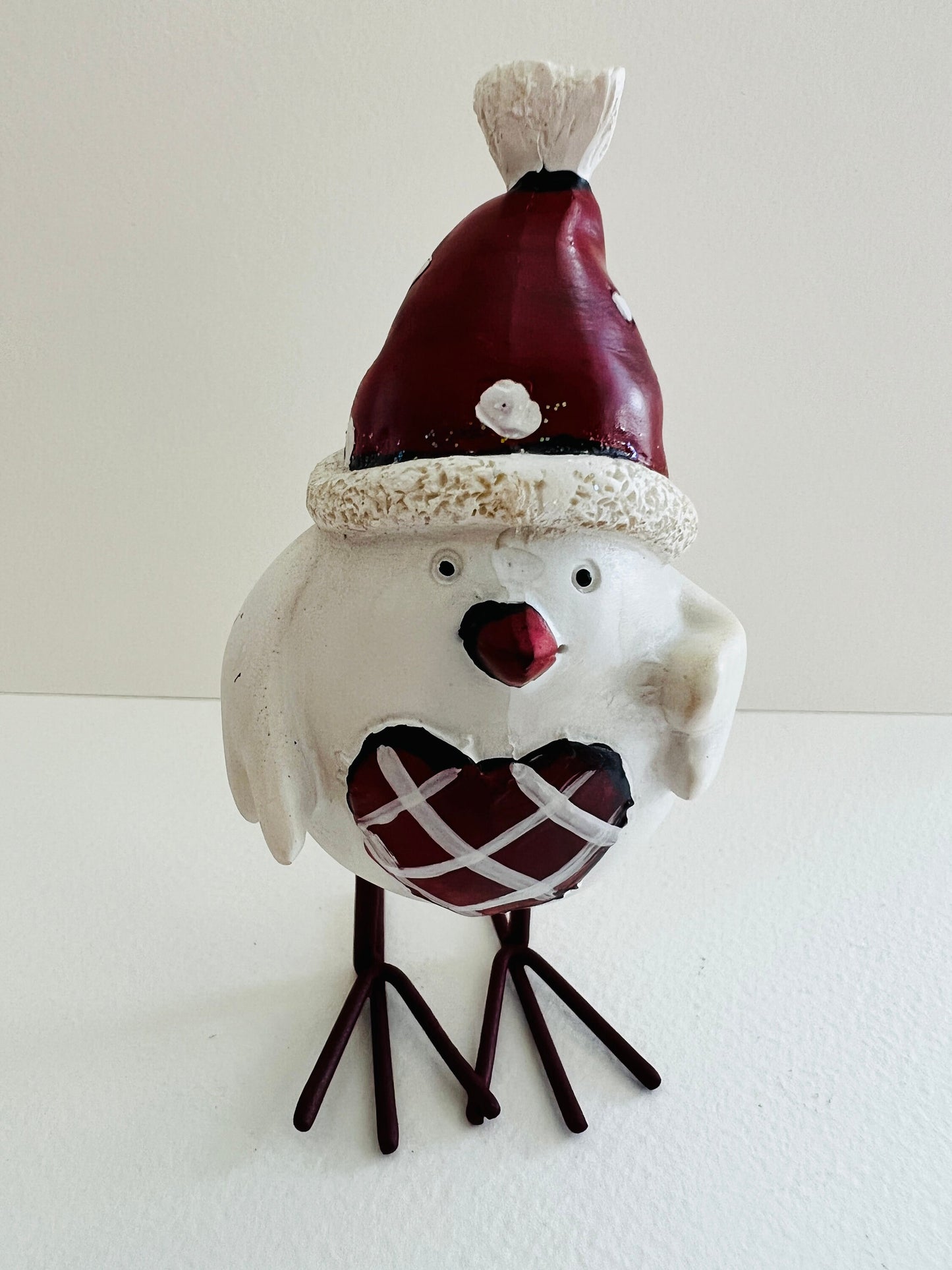 Set of three hand finished robin Christmas ornaments with festive hats, scarves and red heart details. Rustic woodland style bird decorations in cream, burgundy and red tones, perfect for Christmas tree décor, festive styling and stocking filler gifts.