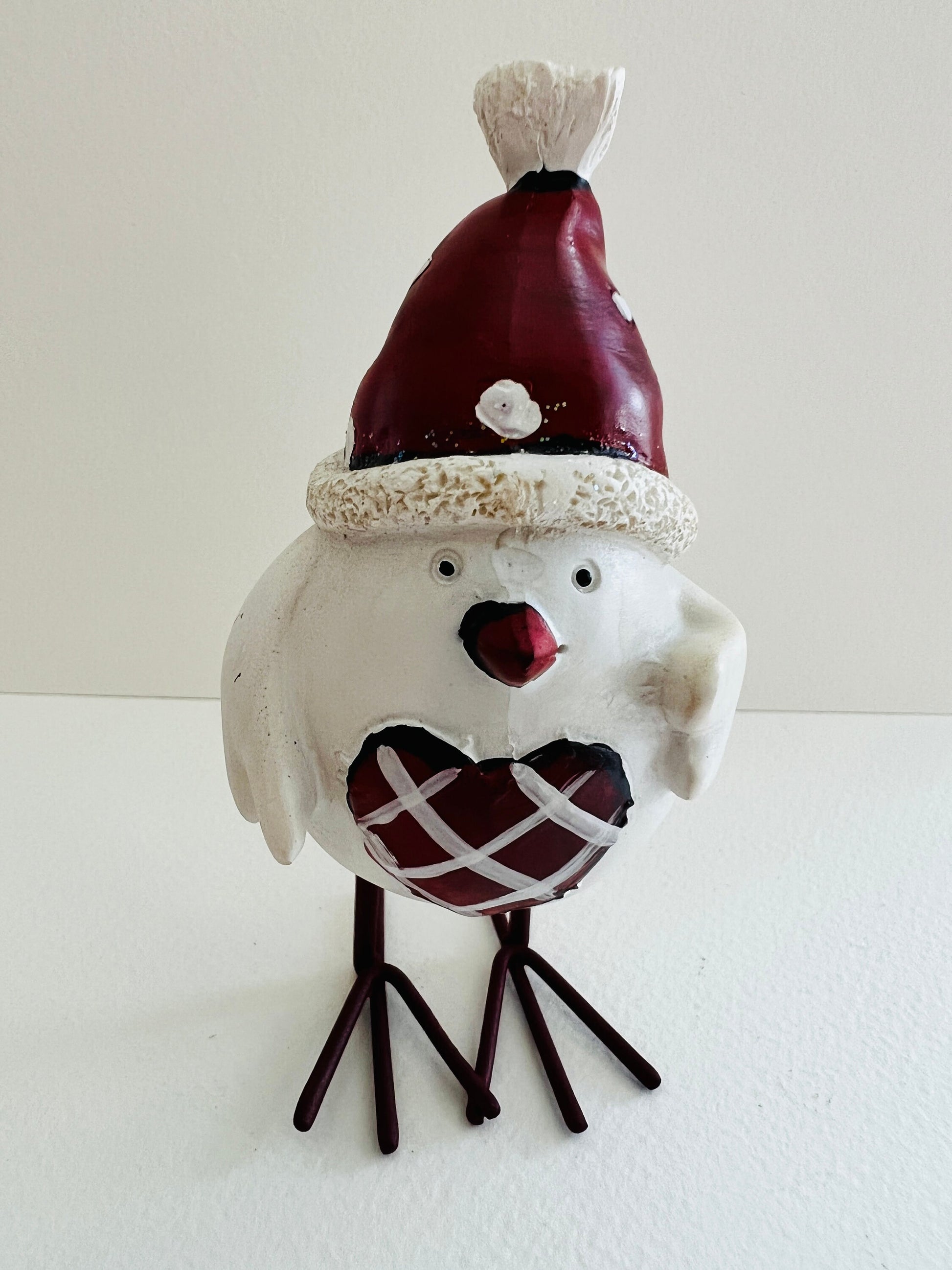 Set of three hand finished robin Christmas ornaments with festive hats, scarves and red heart details. Rustic woodland style bird decorations in cream, burgundy and red tones, perfect for Christmas tree décor, festive styling and stocking filler gifts.