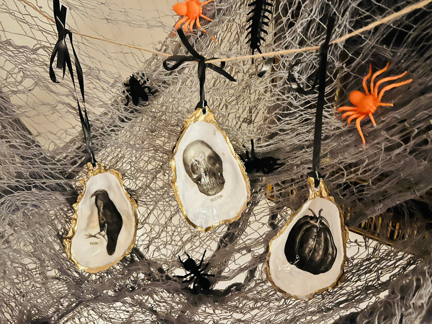 gothic ornaments, halloween oyster shell, gilded oyster hanging ornaments, coastal gothic decor, gothic christmas ornament, skull oyster shell decoration, pumpkin oyster shell ornament, raven oyster shell hanging decor, spooky oyster shell trinket dish, gothic halloween tree ornament, handmade gothic oyster shell gift, oyster shell gothic home accessory, dark gothic oyster shell decor, halloween oyster shell candy dish, gothic oyster shell jewellery holder, handmade oyster art UK