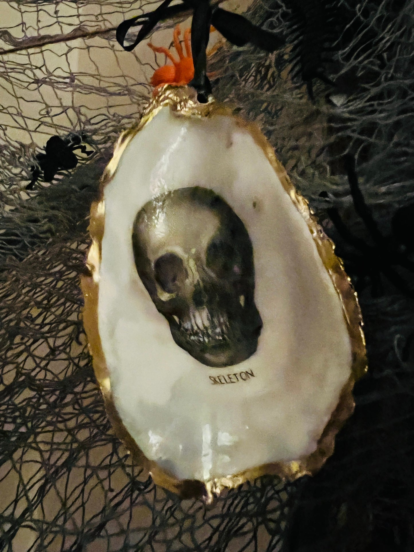 gothic ornaments, halloween oyster shell, gilded oyster hanging ornaments, coastal gothic decor, gothic christmas ornament, skull oyster shell decoration, pumpkin oyster shell ornament, raven oyster shell hanging decor, spooky oyster shell trinket dish, gothic halloween tree ornament, handmade gothic oyster shell gift, oyster shell gothic home accessory, dark gothic oyster shell decor, halloween oyster shell candy dish, gothic oyster shell jewellery holder, handmade oyster art UK