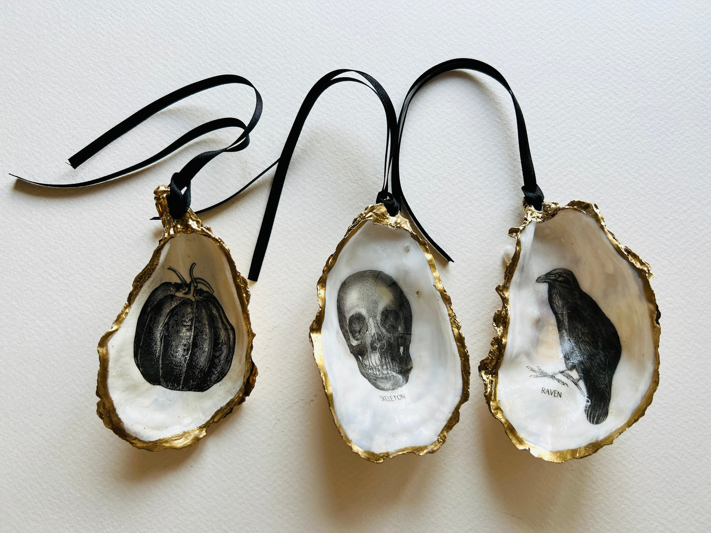 gothic ornaments, halloween oyster shell, gilded oyster hanging ornaments, coastal gothic decor, gothic christmas ornament, skull oyster shell decoration, pumpkin oyster shell ornament, raven oyster shell hanging decor, spooky oyster shell trinket dish, gothic halloween tree ornament, handmade gothic oyster shell gift, oyster shell gothic home accessory, dark gothic oyster shell decor, halloween oyster shell candy dish, gothic oyster shell jewellery holder, handmade oyster art UK