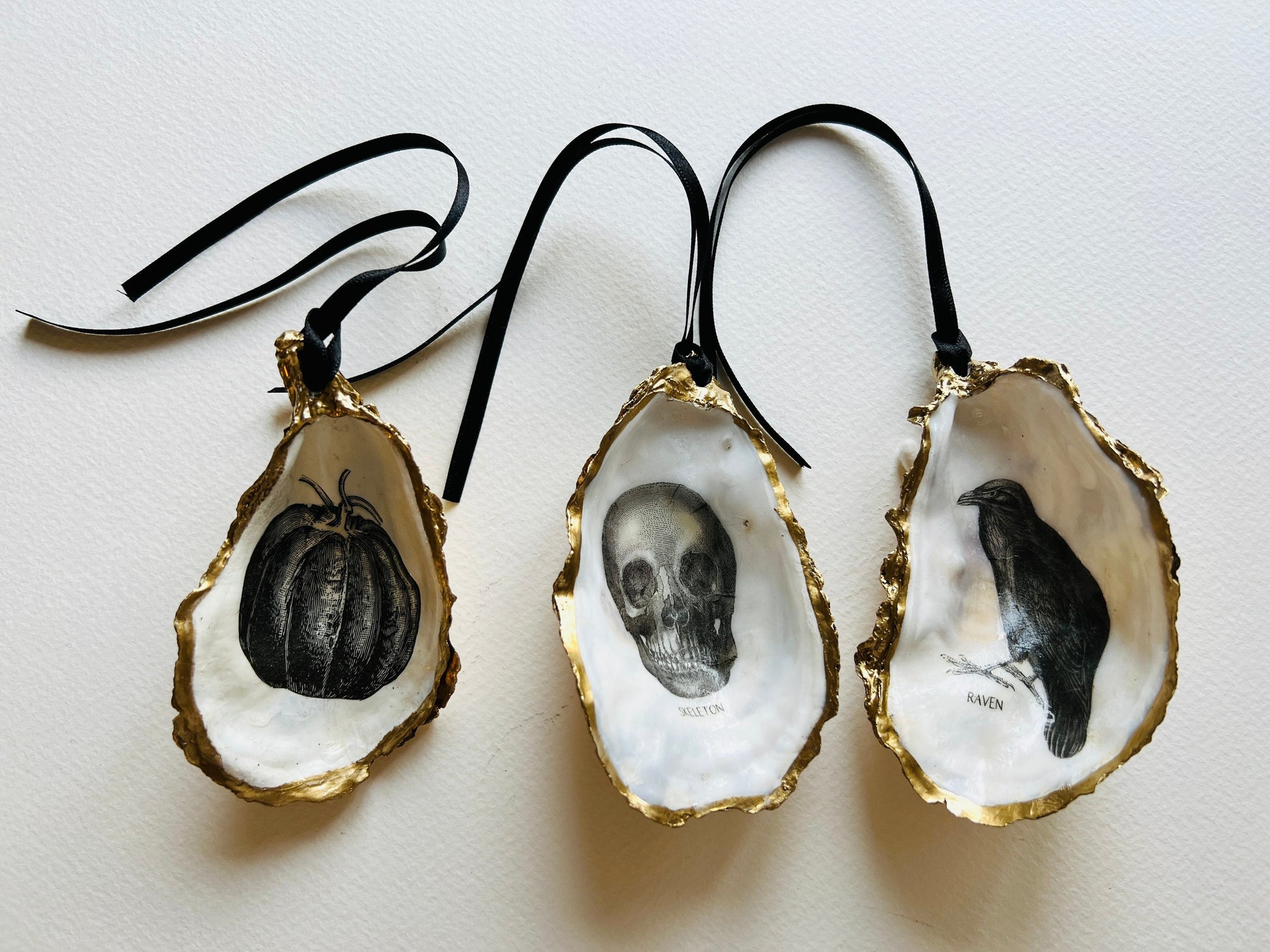 gothic ornaments, halloween oyster shell, gilded oyster hanging ornaments, coastal gothic decor, gothic christmas ornament, skull oyster shell decoration, pumpkin oyster shell ornament, raven oyster shell hanging decor, spooky oyster shell trinket dish, gothic halloween tree ornament, handmade gothic oyster shell gift, oyster shell gothic home accessory, dark gothic oyster shell decor, halloween oyster shell candy dish, gothic oyster shell jewellery holder, handmade oyster art UK