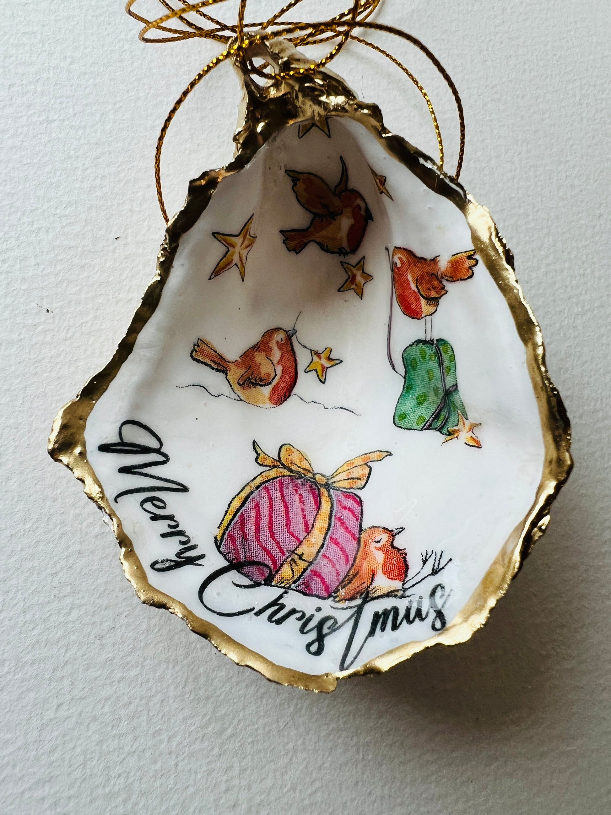 Robin bird oyster shell ornament, handmade in Dorset and gilded with liquid gold leaf. Unique coastal Christmas tree decoration or stocking filler. Can be used as a trinket dish, candy dish, or jewellery holder. Perfect bird lover gift, rustic festive ornament, eco-friendly holiday décor, oyster shell Christmas gift, handmade UK artisan bird decoration, coastal nature inspired home décor, robin bird keepsake.