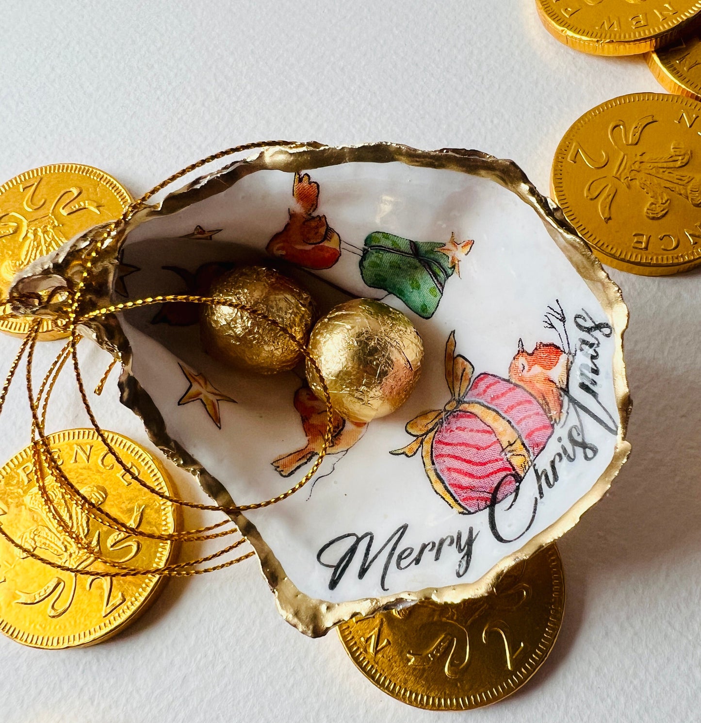 Robin bird oyster shell ornament, handmade in Dorset and gilded with liquid gold leaf. Unique coastal Christmas tree decoration or stocking filler. Can be used as a trinket dish, candy dish, or jewellery holder. Perfect bird lover gift, rustic festive ornament, eco-friendly holiday décor, oyster shell Christmas gift, handmade UK artisan bird decoration, coastal nature inspired home décor, robin bird keepsake.