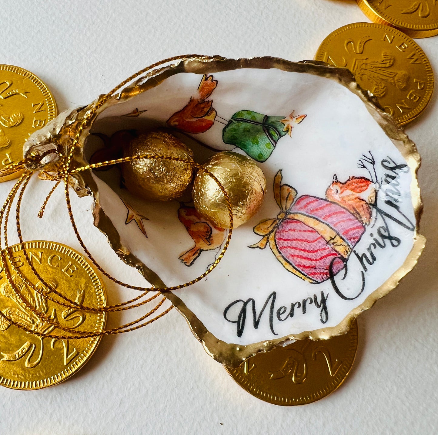 Robin bird oyster shell ornament, handmade in Dorset and gilded with liquid gold leaf. Unique coastal Christmas tree decoration or stocking filler. Can be used as a trinket dish, candy dish, or jewellery holder. Perfect bird lover gift, rustic festive ornament, eco-friendly holiday décor, oyster shell Christmas gift, handmade UK artisan bird decoration, coastal nature inspired home décor, robin bird keepsake.