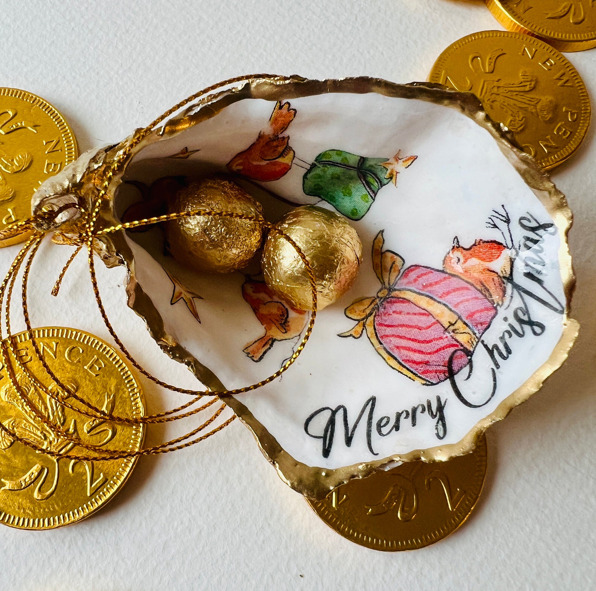 Robin bird oyster shell ornament, handmade in Dorset and gilded with liquid gold leaf. Unique coastal Christmas tree decoration or stocking filler. Can be used as a trinket dish, candy dish, or jewellery holder. Perfect bird lover gift, rustic festive ornament, eco-friendly holiday décor, oyster shell Christmas gift, handmade UK artisan bird decoration, coastal nature inspired home décor, robin bird keepsake.