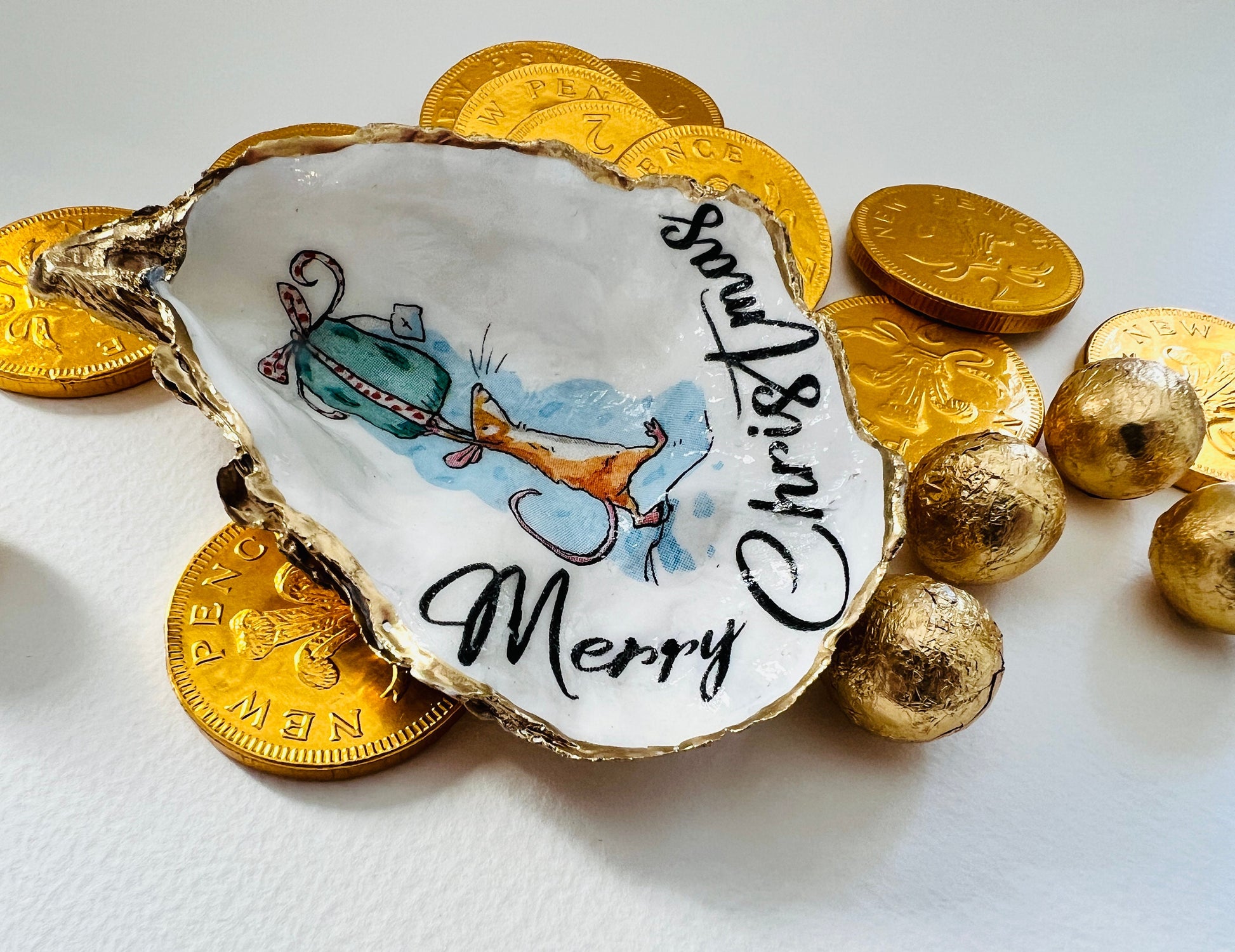 Handmade Christmas mouse oyster shell ornament. Dorset oyster shell trinket dish gilded with real gold leaf and sealed with resin. Use as festive candy dish, jewellery holder, or hanging Christmas tree ornament. Unique eco-friendly oyster shell gift, stocking filler, or table decoration. Coastal holiday décor, perfect handmade UK Christmas present, anniversary or winter wedding favour, individually crafted from natural Dorset shells.