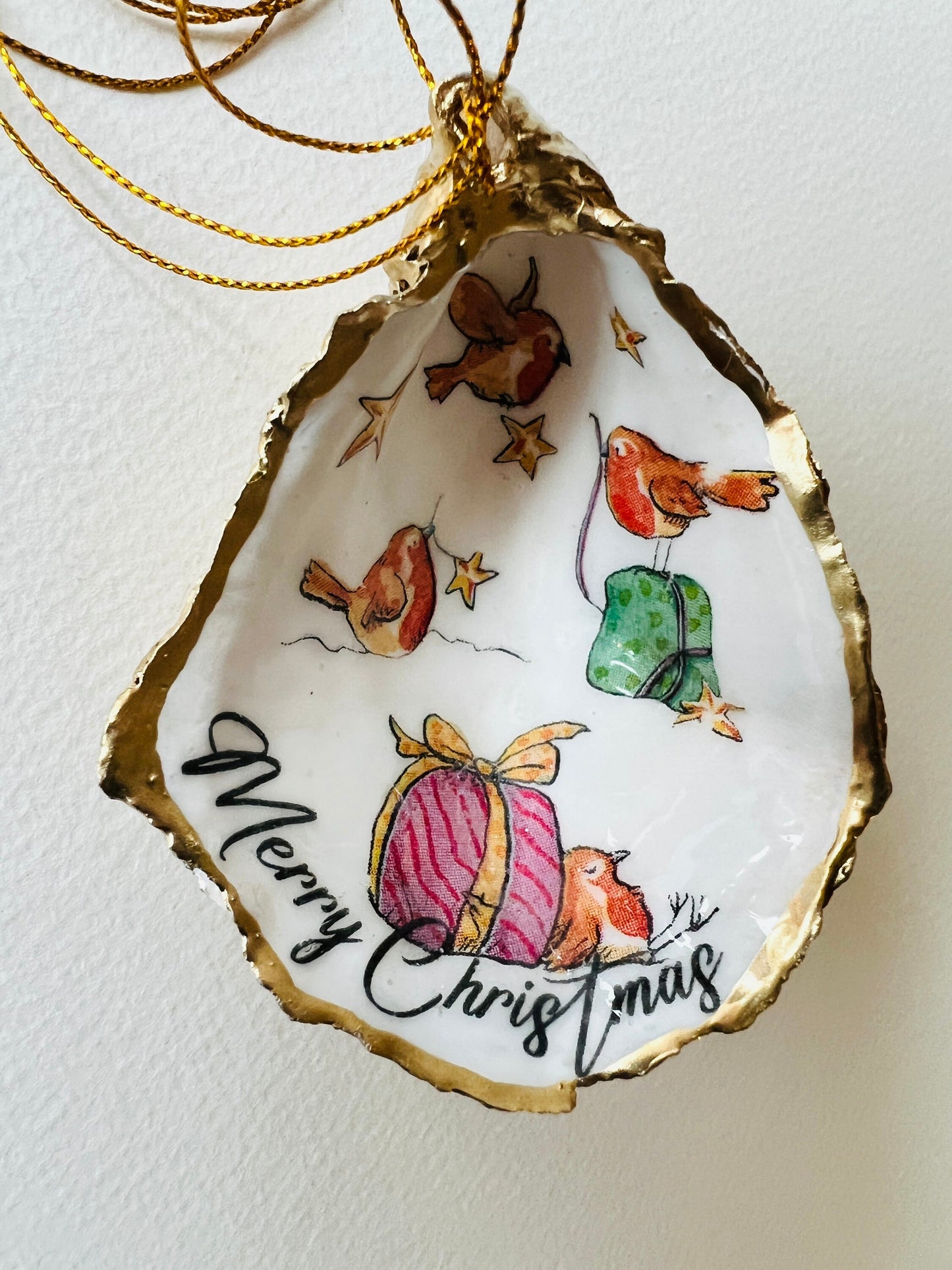 Robin bird oyster shell ornament, handmade in Dorset and gilded with liquid gold leaf. Unique coastal Christmas tree decoration or stocking filler. Can be used as a trinket dish, candy dish, or jewellery holder. Perfect bird lover gift, rustic festive ornament, eco-friendly holiday décor, oyster shell Christmas gift, handmade UK artisan bird decoration, coastal nature inspired home décor, robin bird keepsake.