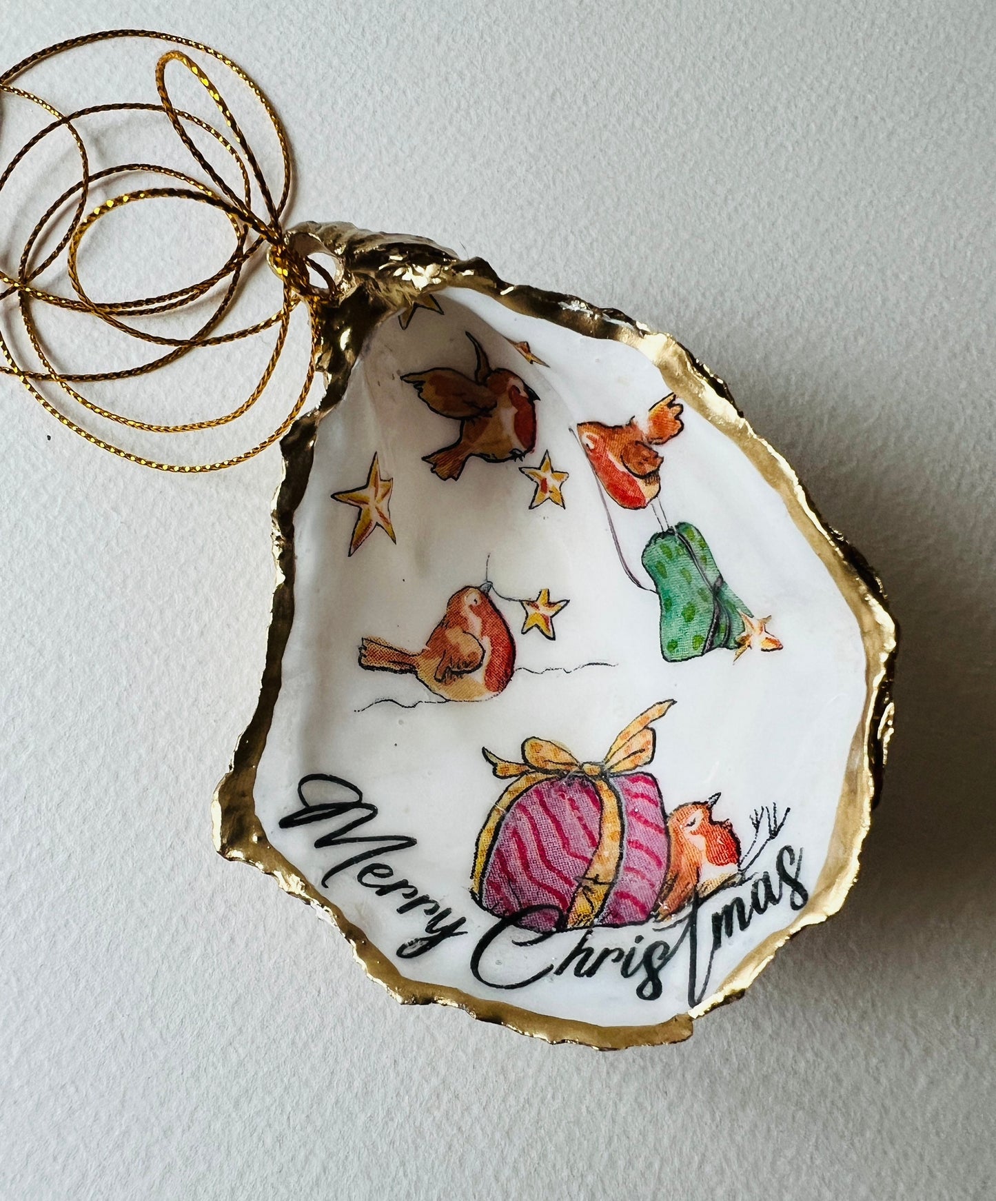 Robin bird oyster shell ornament, handmade in Dorset and gilded with liquid gold leaf. Unique coastal Christmas tree decoration or stocking filler. Can be used as a trinket dish, candy dish, or jewellery holder. Perfect bird lover gift, rustic festive ornament, eco-friendly holiday décor, oyster shell Christmas gift, handmade UK artisan bird decoration, coastal nature inspired home décor, robin bird keepsake.