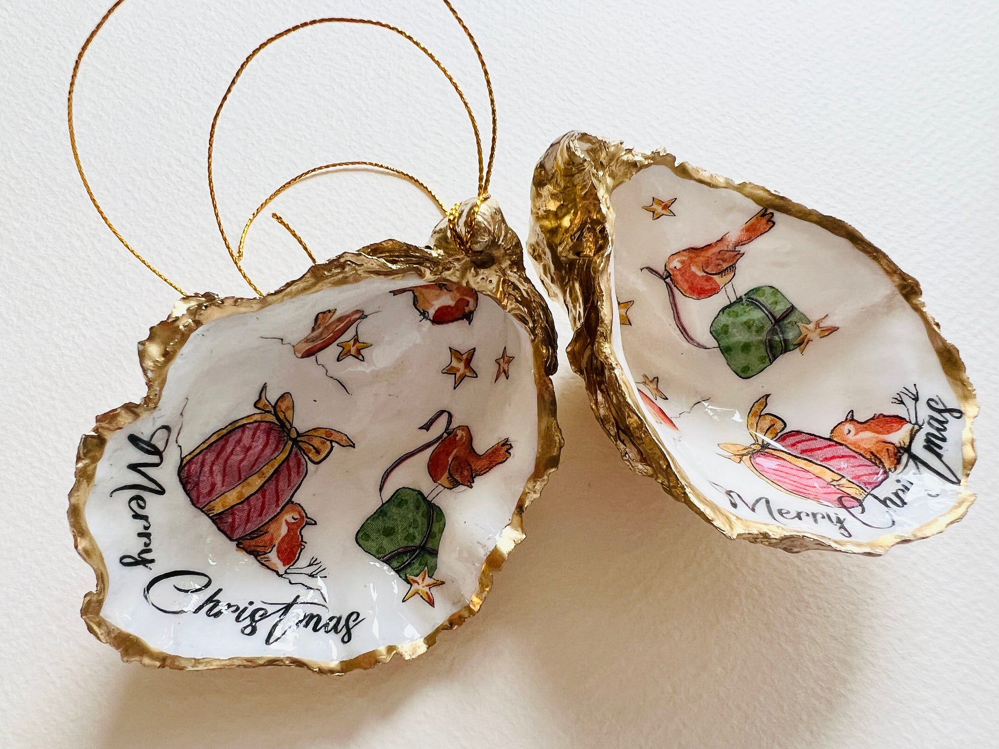 Robin bird oyster shell ornament, handmade in Dorset and gilded with liquid gold leaf. Unique coastal Christmas tree decoration or stocking filler. Can be used as a trinket dish, candy dish, or jewellery holder. Perfect bird lover gift, rustic festive ornament, eco-friendly holiday décor, oyster shell Christmas gift, handmade UK artisan bird decoration, coastal nature inspired home décor, robin bird keepsake.