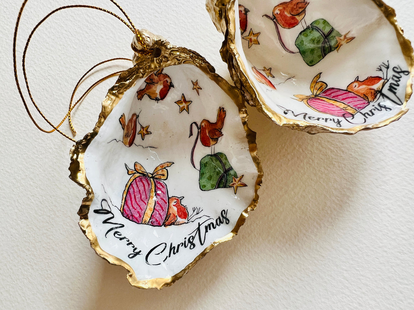 Robin bird oyster shell ornament, handmade in Dorset and gilded with liquid gold leaf. Unique coastal Christmas tree decoration or stocking filler. Can be used as a trinket dish, candy dish, or jewellery holder. Perfect bird lover gift, rustic festive ornament, eco-friendly holiday décor, oyster shell Christmas gift, handmade UK artisan bird decoration, coastal nature inspired home décor, robin bird keepsake.