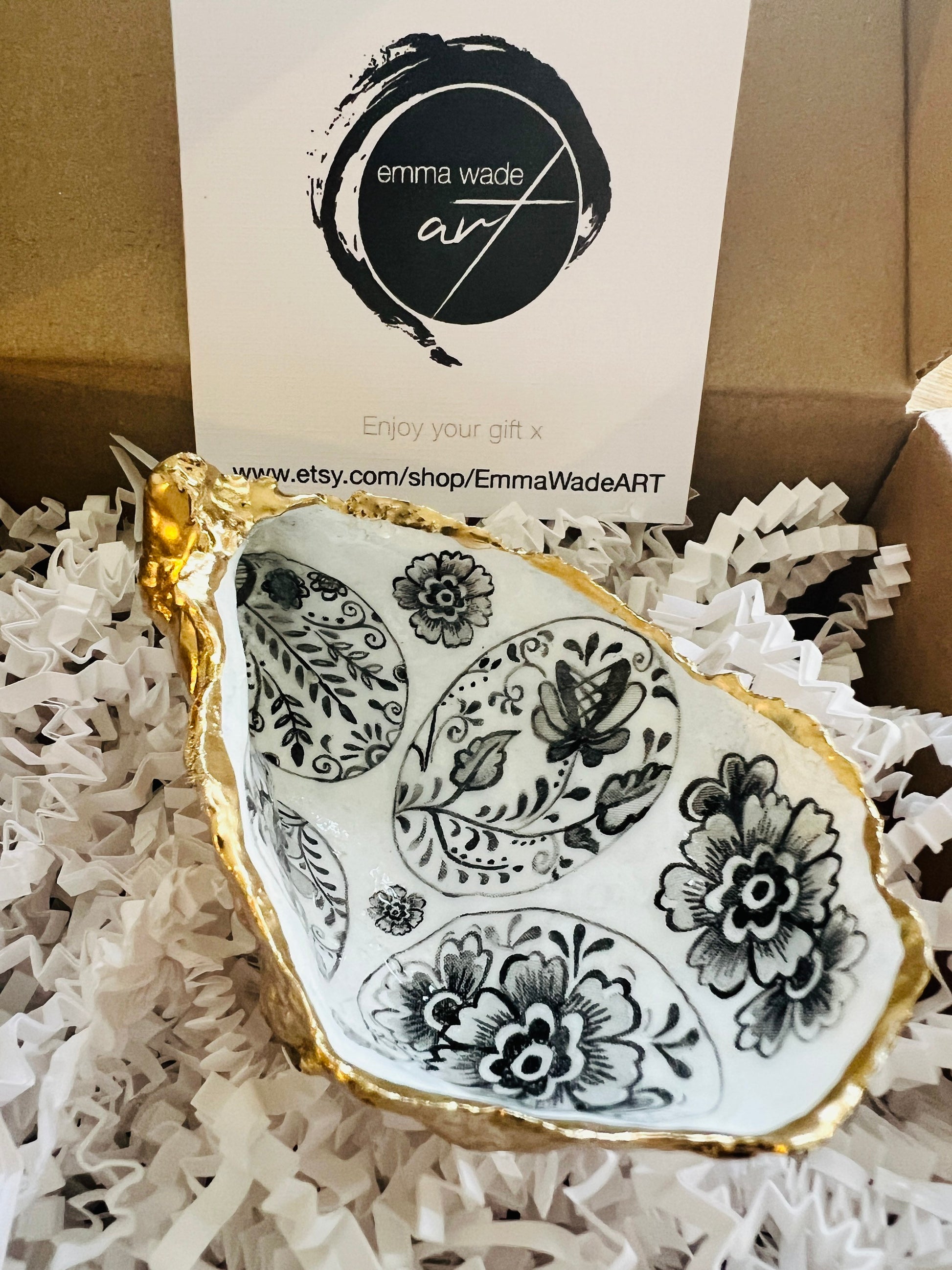 Handmade Dorset oyster shell dish featuring a decorative grey eggs design. Each oyster shell is finished with liquid gold leaf edging and reverse, sealed with crystal-clear resin for a glossy, durable shine. Unique and symbolic, the egg represents new life, fertility, hope, and luck, making this piece a thoughtful and meaningful gift. Ideal as a jewellery dish, oyster ring holder, trinket tray, or keepsake ornament. A coastal-inspired handmade gift for anniversaries, Easter, or Christmas.