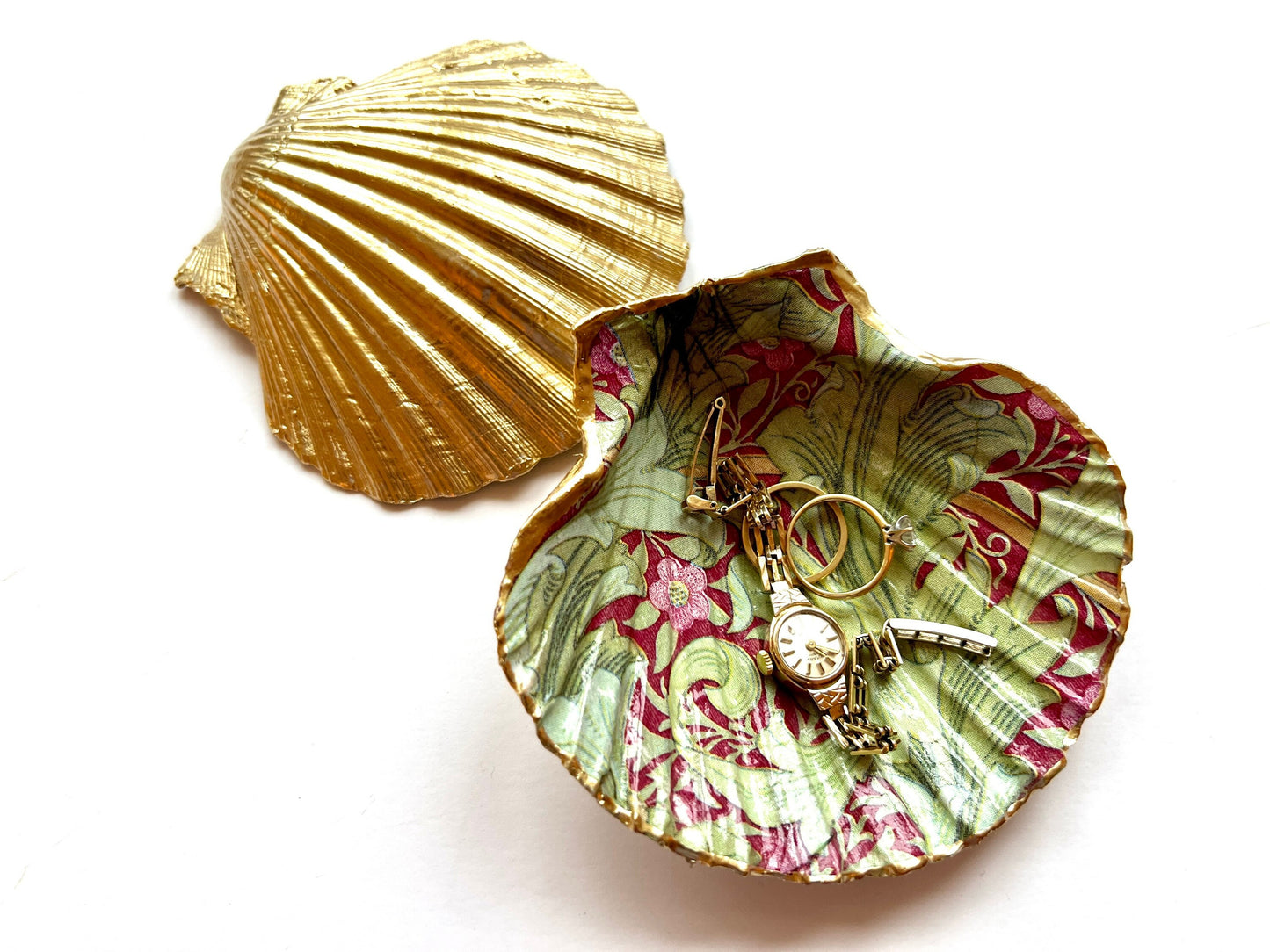 Handmade Dorset scallop shell trinket dish featuring William Morris Granville Bordeaux pattern, finished with real gold leaf edging and a glossy resin coating. A sustainable coastal jewellery dish and ring holder, individually handcrafted in the UK. Ideal as a unique gift for her, wedding or anniversary present, or elegant home décor accent inspired by nature and classic Arts and Crafts design.