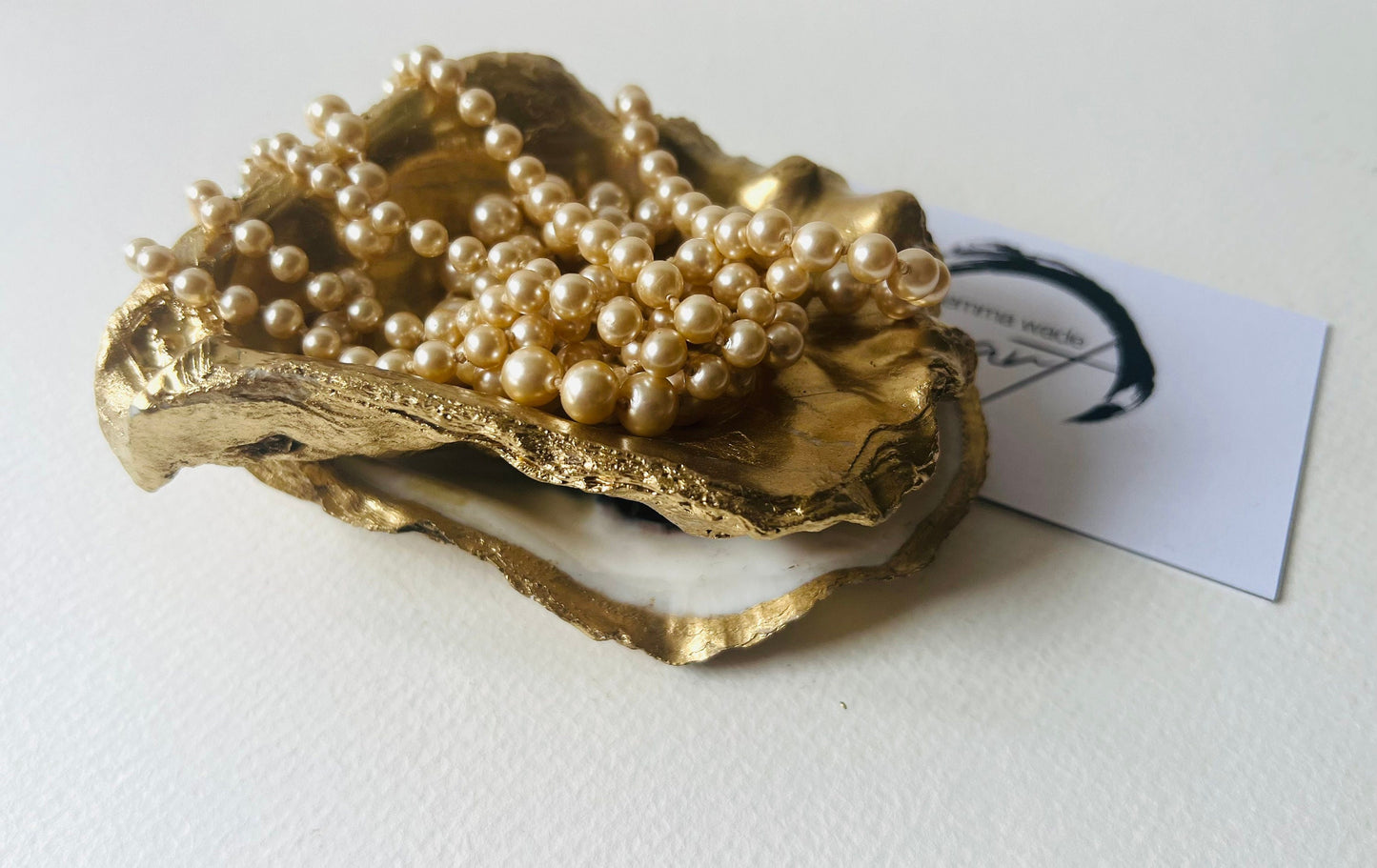 Gold leaf oyster shell jewellery dish with pearl finish, handmade Dorset oyster shell ring holder and trinket dish. Matching flat oyster base with gilded edges, eco-friendly coastal home decor. Unique oyster shell gift, wedding ring box, anniversary present, salt pinch pot, nautical bathroom accessory. Handcrafted shell ornament, sustainable oyster decor, handmade UK jewellery storage.