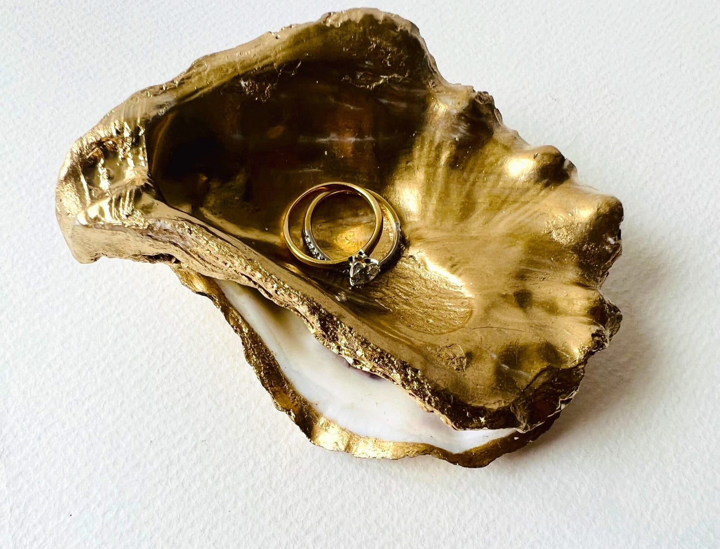 Gold leaf oyster shell jewellery dish with pearl finish, handmade Dorset oyster shell ring holder and trinket dish. Matching flat oyster base with gilded edges, eco-friendly coastal home decor. Unique oyster shell gift, wedding ring box, anniversary present, salt pinch pot, nautical bathroom accessory. Handcrafted shell ornament, sustainable oyster decor, handmade UK jewellery storage.