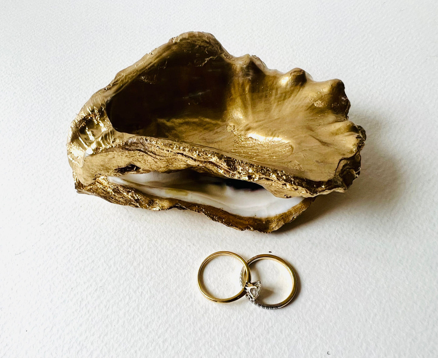 Gold leaf oyster shell jewellery dish with pearl finish, handmade Dorset oyster shell ring holder and trinket dish. Matching flat oyster base with gilded edges, eco-friendly coastal home decor. Unique oyster shell gift, wedding ring box, anniversary present, salt pinch pot, nautical bathroom accessory. Handcrafted shell ornament, sustainable oyster decor, handmade UK jewellery storage.