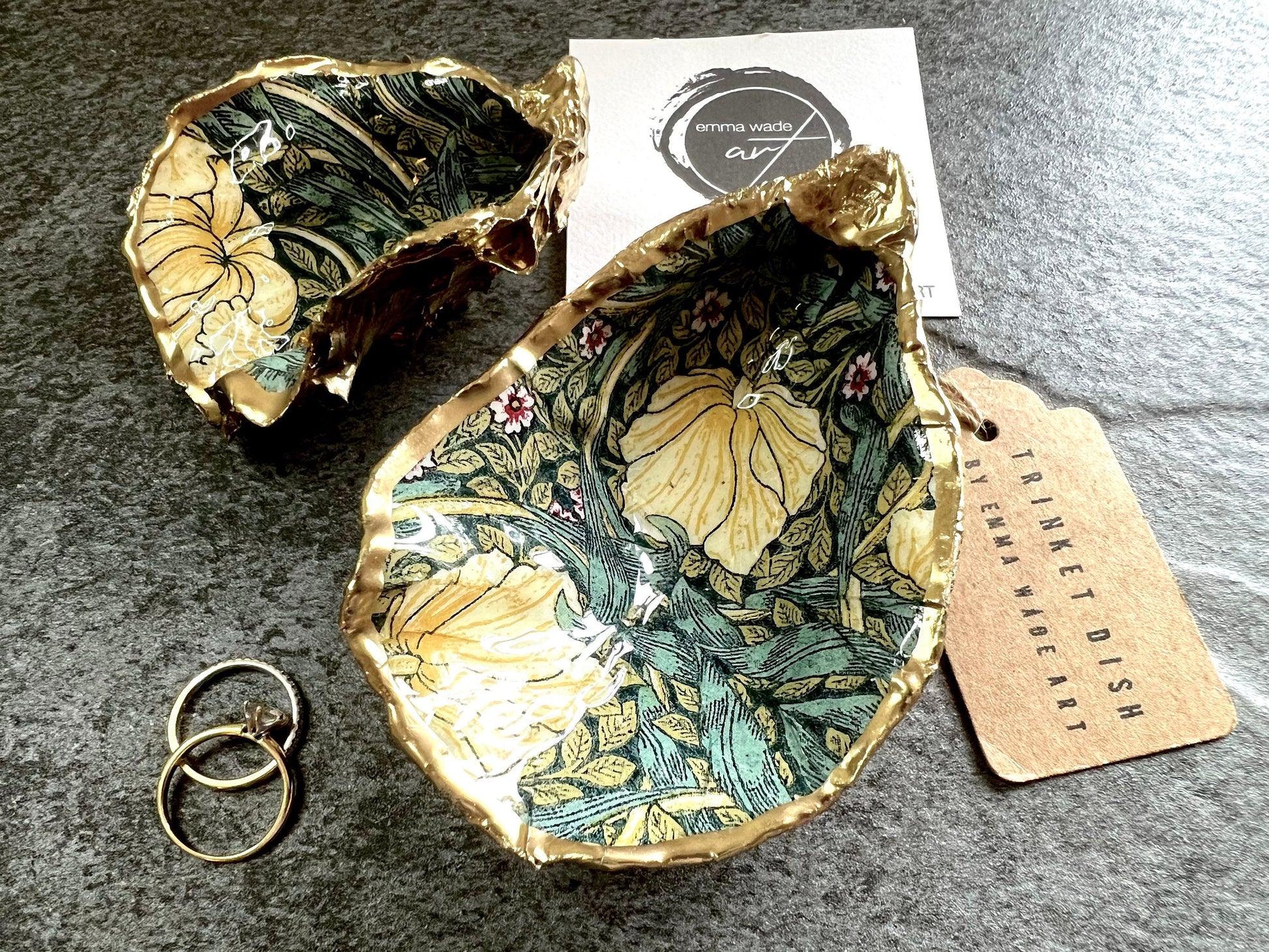 William Morris Golden Green Pimpernel oyster shell ring dish with gold leaf edge. A unique shell ring holder, ring tray, and jewellery organiser for rings, earrings, or cufflinks. Each shell features an art inspired floral design and is individually handmade from Dorset shells. Perfect as a trinket dish for bedside or dressing table storage. A thoughtful gift for weddings, anniversaries, birthdays, bridesmaids, or Christmas. A sustainable decorative keepsake for any jewellery lover.