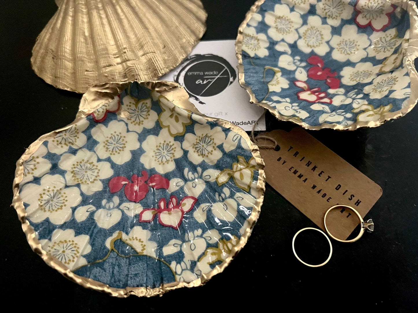 Japanese Sakura cherry blossom floral scallop shell trinket dish with blue, cream and red botanical flower design, hand finished with liquid gold leaf edging and glossy resin. Handmade coastal jewellery tray and ring dish inspired by Japanese floral art and Dorset coastal décor.