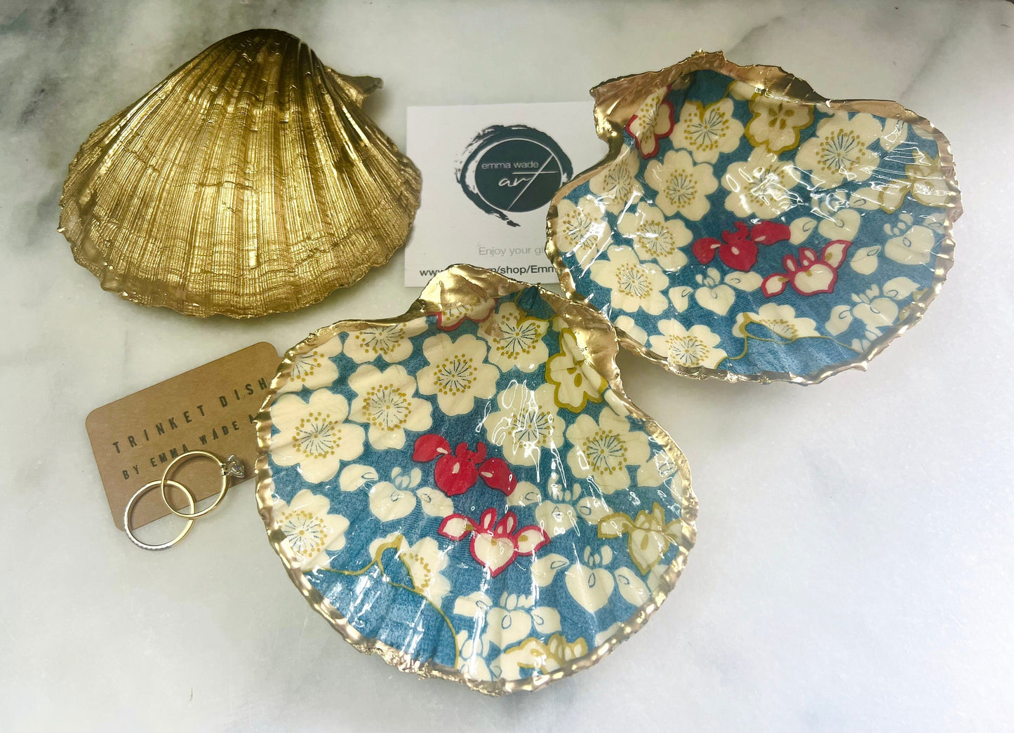 Japanese Sakura cherry blossom floral scallop shell trinket dish with blue, cream and red botanical flower design, hand finished with liquid gold leaf edging and glossy resin. Handmade coastal jewellery tray and ring dish inspired by Japanese floral art and Dorset coastal décor.