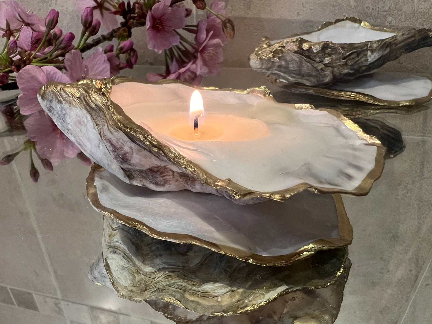 oyster shell candle, gold oyster candle, gilded oyster shells, hand poured candle, coastal decor, ocean inspired candle, beach home decor, sustainable candle, handmade in Surrey, luxury shell candle, sea lover gift, oyster shell pair, artisan candle, eco friendly candle, gold rim shell, nautical decor, ocean gift, coastal homeware, handmade oyster shell candle, shell wedding decor, seaside candle, mother of pearl shell, gold edged candle, beach cottage style, elegant coastal gift