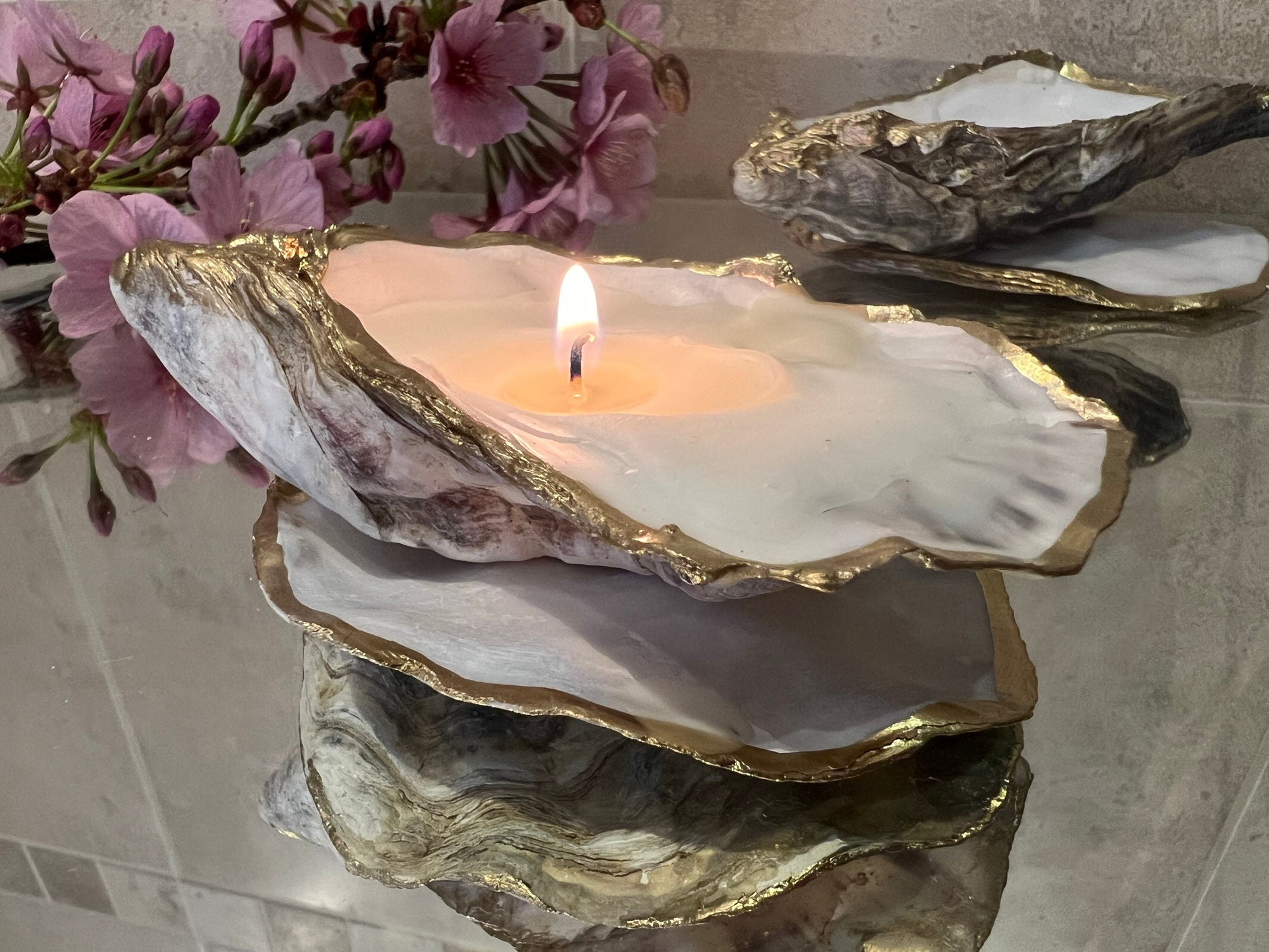 oyster shell candle, gold oyster candle, gilded oyster shells, hand poured candle, coastal decor, ocean inspired candle, beach home decor, sustainable candle, handmade in Surrey, luxury shell candle, sea lover gift, oyster shell pair, artisan candle, eco friendly candle, gold rim shell, nautical decor, ocean gift, coastal homeware, handmade oyster shell candle, shell wedding decor, seaside candle, mother of pearl shell, gold edged candle, beach cottage style, elegant coastal gift