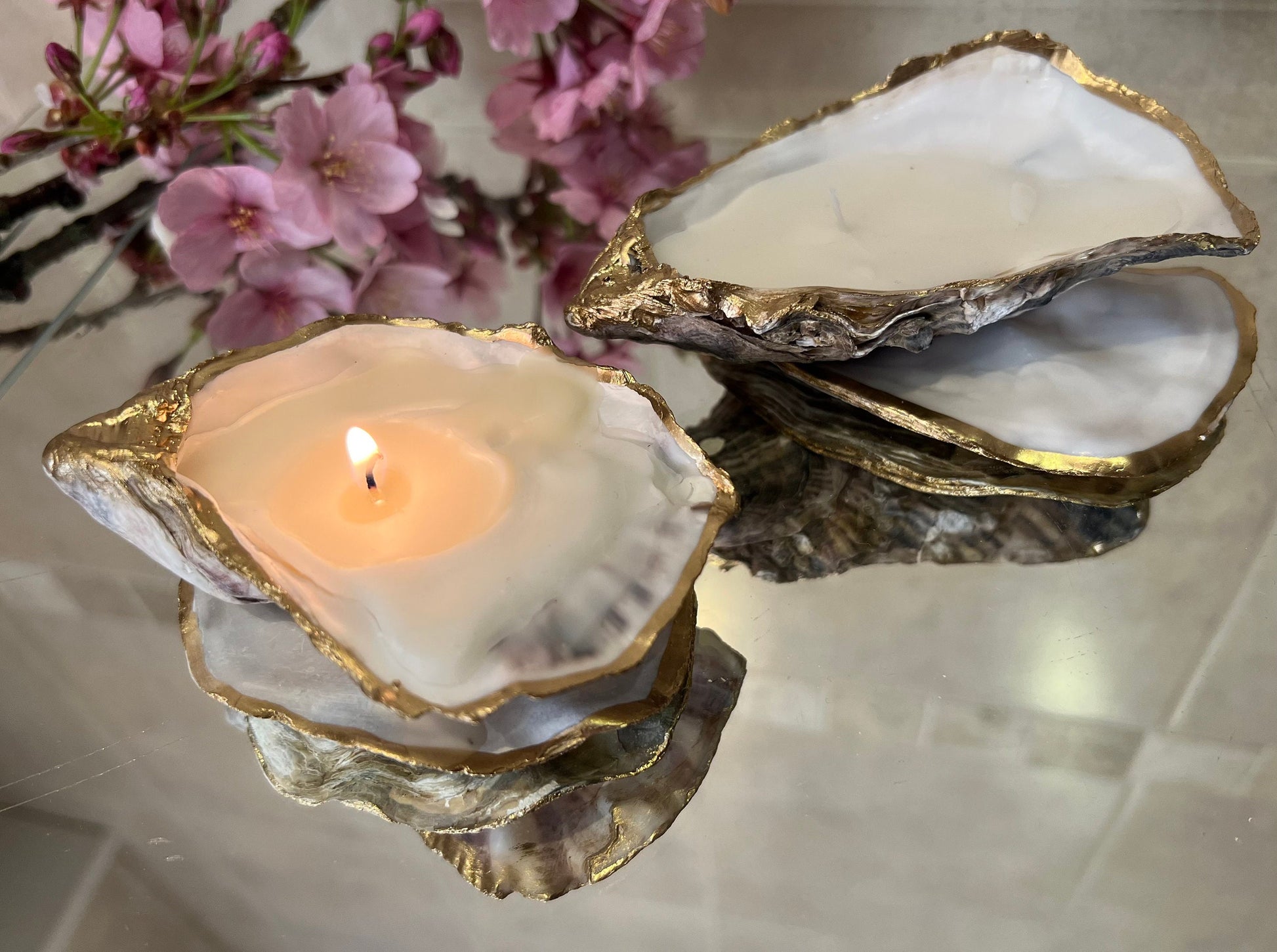 oyster shell candle, gold oyster candle, gilded oyster shells, hand poured candle, coastal decor, ocean inspired candle, beach home decor, sustainable candle, handmade in Surrey, luxury shell candle, sea lover gift, oyster shell pair, artisan candle, eco friendly candle, gold rim shell, nautical decor, ocean gift, coastal homeware, handmade oyster shell candle, shell wedding decor, seaside candle, mother of pearl shell, gold edged candle, beach cottage style, elegant coastal gift