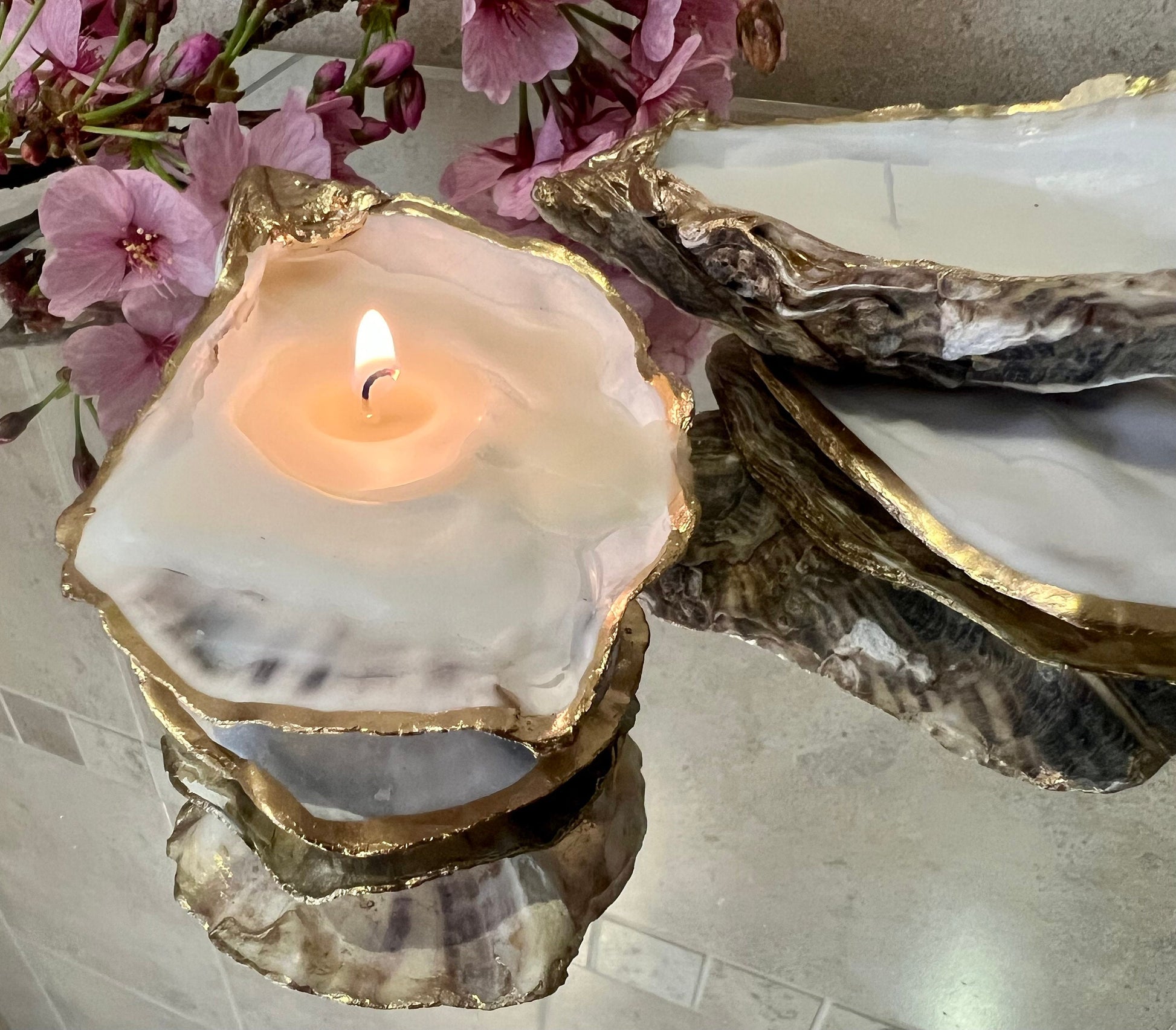 oyster shell candle, gold oyster candle, gilded oyster shells, hand poured candle, coastal decor, ocean inspired candle, beach home decor, sustainable candle, handmade in Surrey, luxury shell candle, sea lover gift, oyster shell pair, artisan candle, eco friendly candle, gold rim shell, nautical decor, ocean gift, coastal homeware, handmade oyster shell candle, shell wedding decor, seaside candle, mother of pearl shell, gold edged candle, beach cottage style, elegant coastal gift