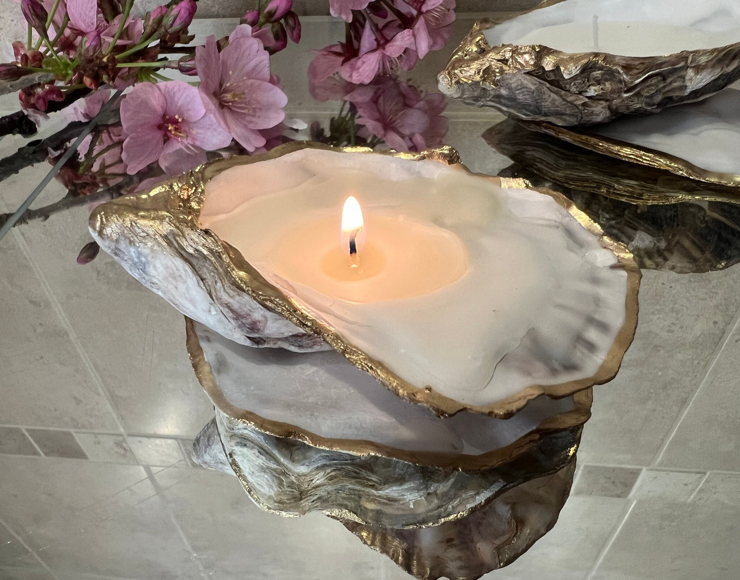 oyster shell candle, gold oyster candle, gilded oyster shells, hand poured candle, coastal decor, ocean inspired candle, beach home decor, sustainable candle, handmade in Surrey, luxury shell candle, sea lover gift, oyster shell pair, artisan candle, eco friendly candle, gold rim shell, nautical decor, ocean gift, coastal homeware, handmade oyster shell candle, shell wedding decor, seaside candle, mother of pearl shell, gold edged candle, beach cottage style, elegant coastal gift