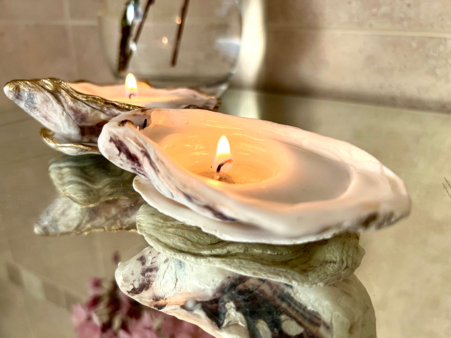 Luxury oyster shell candle hand poured with natural vegetable wax inside a real Dorset oyster shell with gold leaf edging. Coastal candle decor with polished pearl shell interior and artisan handmade styling. Sustainable shell candle gift for weddings, birthdays, spa decor and coastal home interiors.