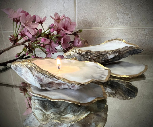 oyster shell candle, gold oyster candle, gilded oyster shells, hand poured candle, coastal decor, ocean inspired candle, beach home decor, sustainable candle, handmade in Surrey, luxury shell candle, sea lover gift, oyster shell pair, artisan candle, eco friendly candle, gold rim shell, nautical decor, ocean gift, coastal homeware, handmade oyster shell candle, shell wedding decor, seaside candle, mother of pearl shell, gold edged candle, beach cottage style, elegant coastal gift