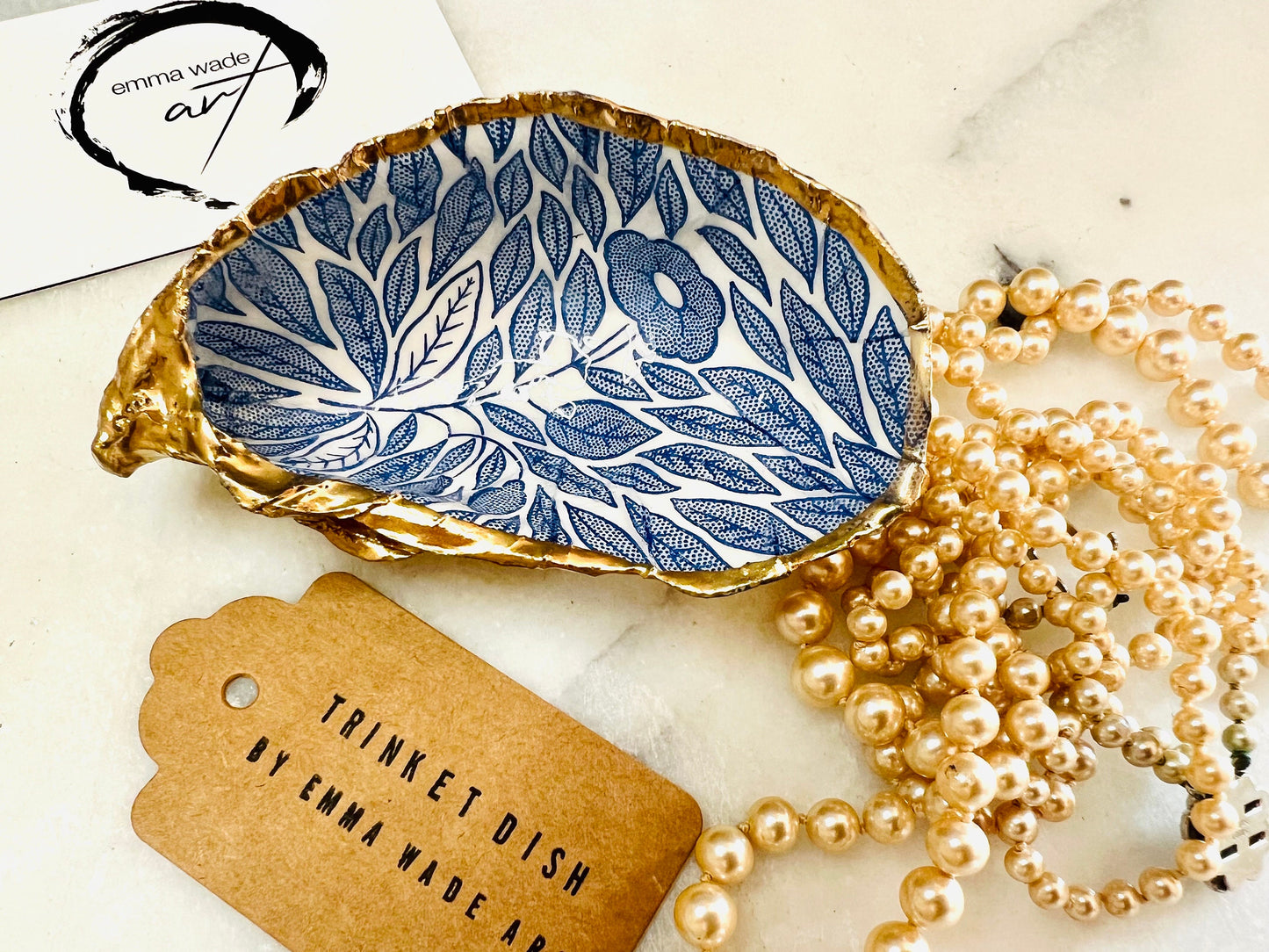 Blue flowers oyster shell trinket dish, Dorset oyster shell gift, gold leaf jewellery holder, handmade coastal decor, nautical bathroom dish, oyster shell ring holder, floral seashell trinket bowl, beach wedding favour, ocean inspired salt pinch pot, eco friendly shell gift, oyster shell spoon rest, seaside home accessory, handmade UK oyster shell dish, coastal jewellery organiser, blue floral oyster shell ornament.