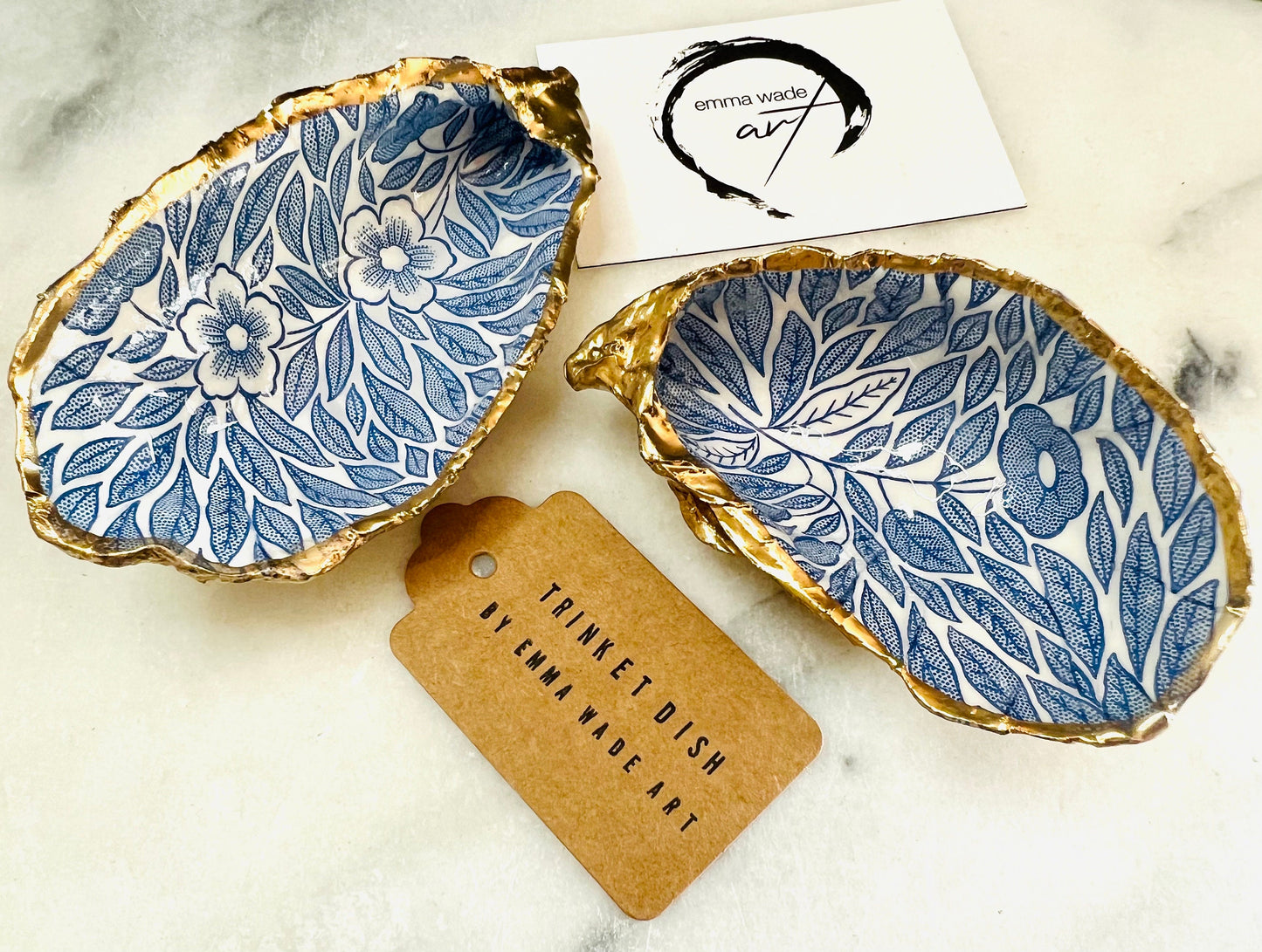 Blue flowers oyster shell trinket dish, Dorset oyster shell gift, gold leaf jewellery holder, handmade coastal decor, nautical bathroom dish, oyster shell ring holder, floral seashell trinket bowl, beach wedding favour, ocean inspired salt pinch pot, eco friendly shell gift, oyster shell spoon rest, seaside home accessory, handmade UK oyster shell dish, coastal jewellery organiser, blue floral oyster shell ornament.