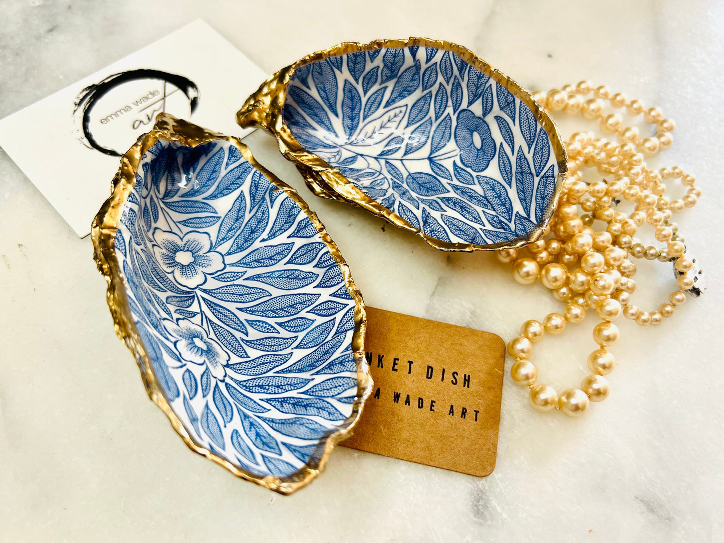 Blue flowers oyster shell trinket dish, Dorset oyster shell gift, gold leaf jewellery holder, handmade coastal decor, nautical bathroom dish, oyster shell ring holder, floral seashell trinket bowl, beach wedding favour, ocean inspired salt pinch pot, eco friendly shell gift, oyster shell spoon rest, seaside home accessory, handmade UK oyster shell dish, coastal jewellery organiser, blue floral oyster shell ornament.
