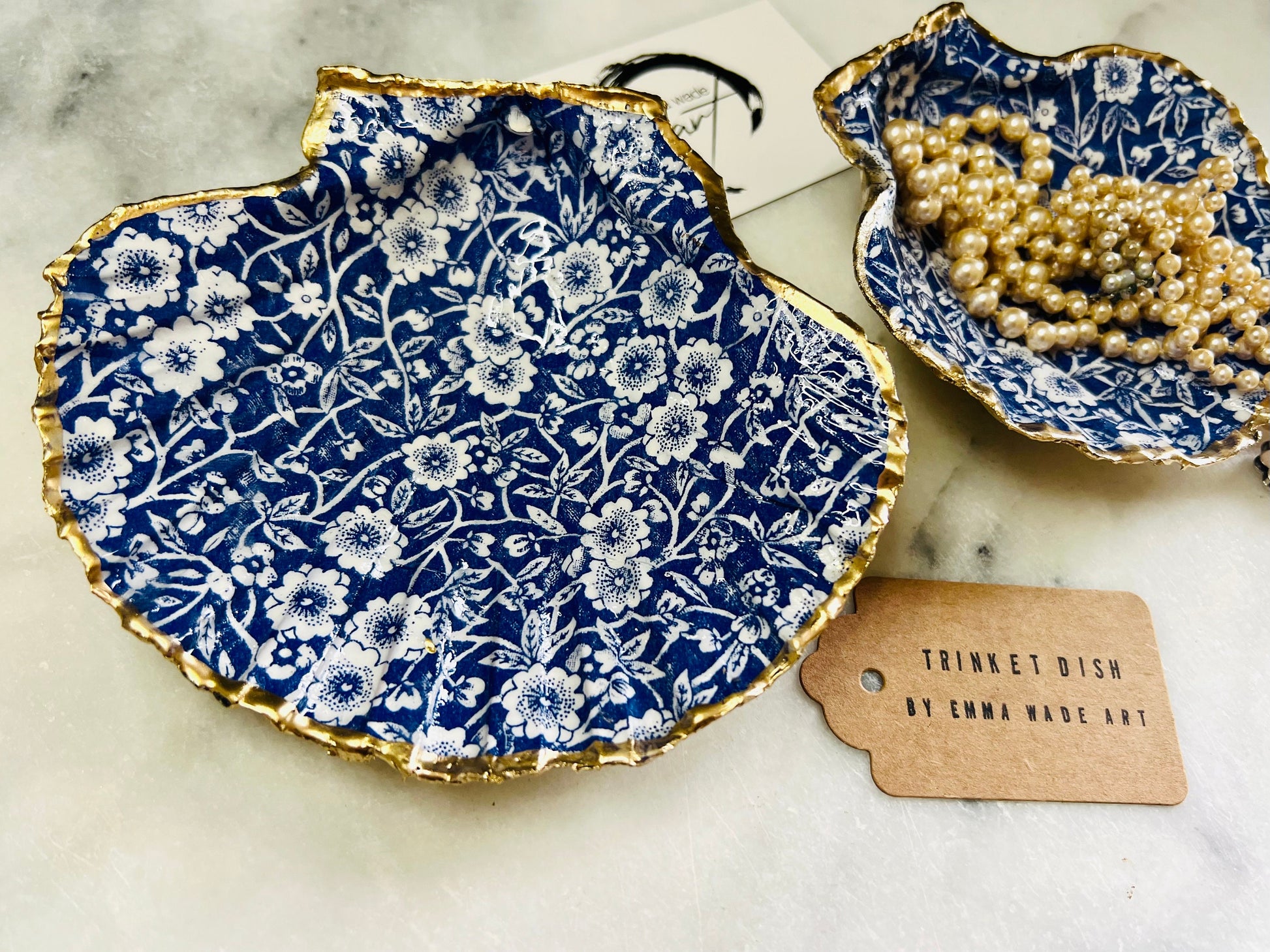 blue and white floral scallop shell dish, Dorset handmade oyster shell jewellery holder, gold leaf scallop shell trinket dish, coastal ring holder dish, sustainable scallop shell ornament, artisan jewellery dish UK, scallop shell salt and pepper pinch pot, floral scallop shell vanity tray, handmade scallop shell gift for her, blue and white coastal home decor dish, unique Dorset scallop shell trinket storage, hand gilded scallop shell decorative dish, UK handmade artisan shell gift
