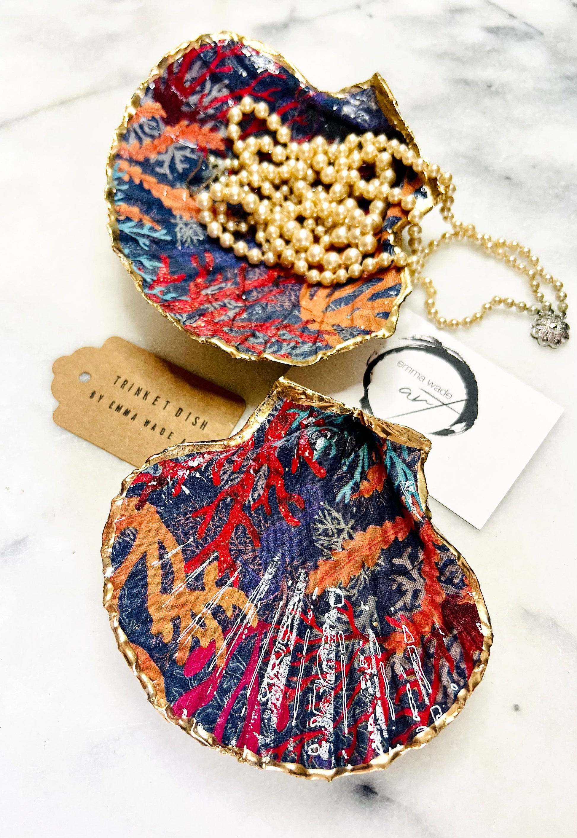 Handmade Dorset scallop shell trinket dish featuring vibrant coral reef and seaweed design in red orange turquoise and navy blue tones, finished with hand gilded gold leaf edging and glossy resin, luxury coastal jewellery holder and ocean inspired decor