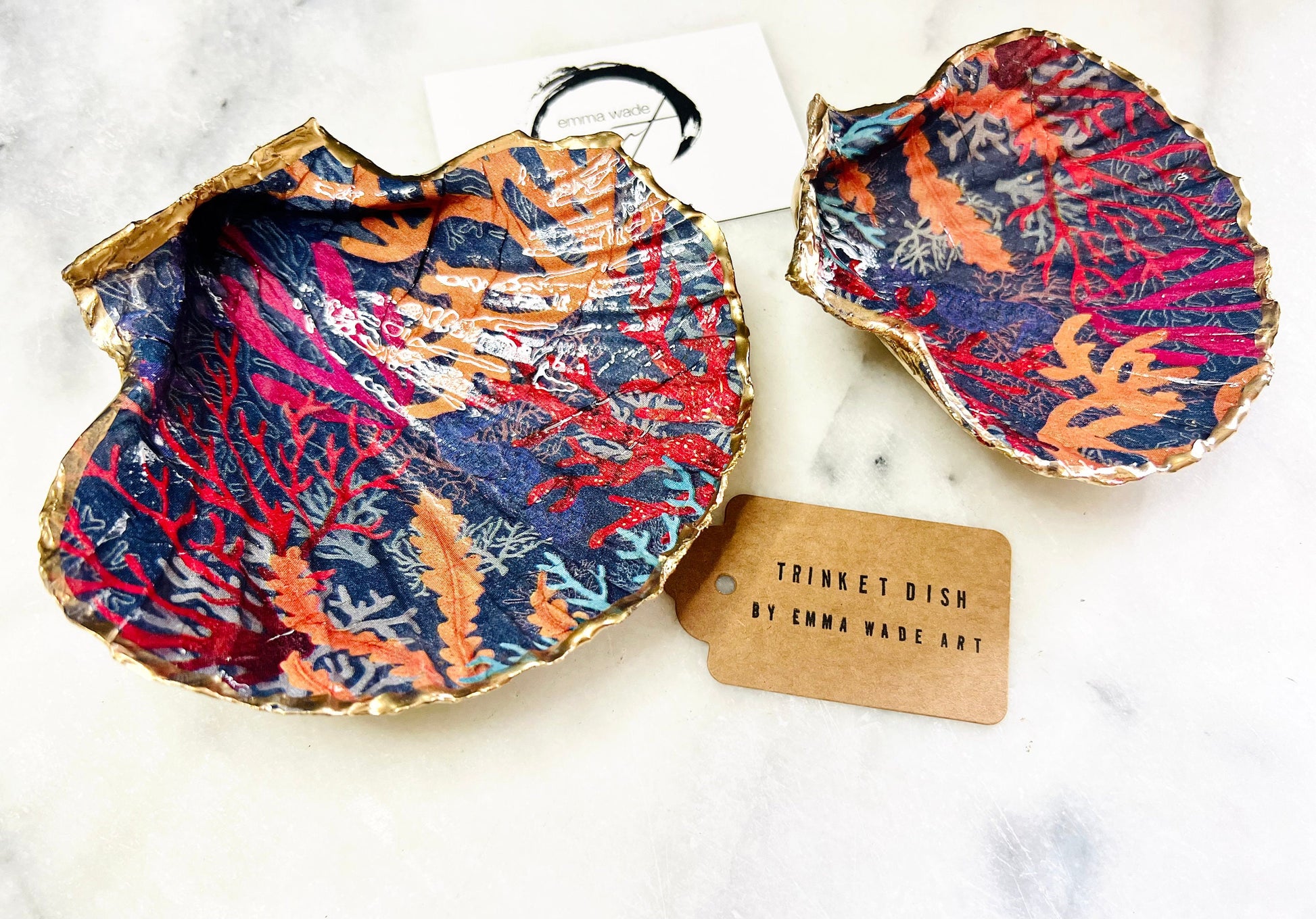 Handmade Dorset scallop shell trinket dish featuring vibrant coral reef and seaweed design in red orange turquoise and navy blue tones, finished with hand gilded gold leaf edging and glossy resin, luxury coastal jewellery holder and ocean inspired decor