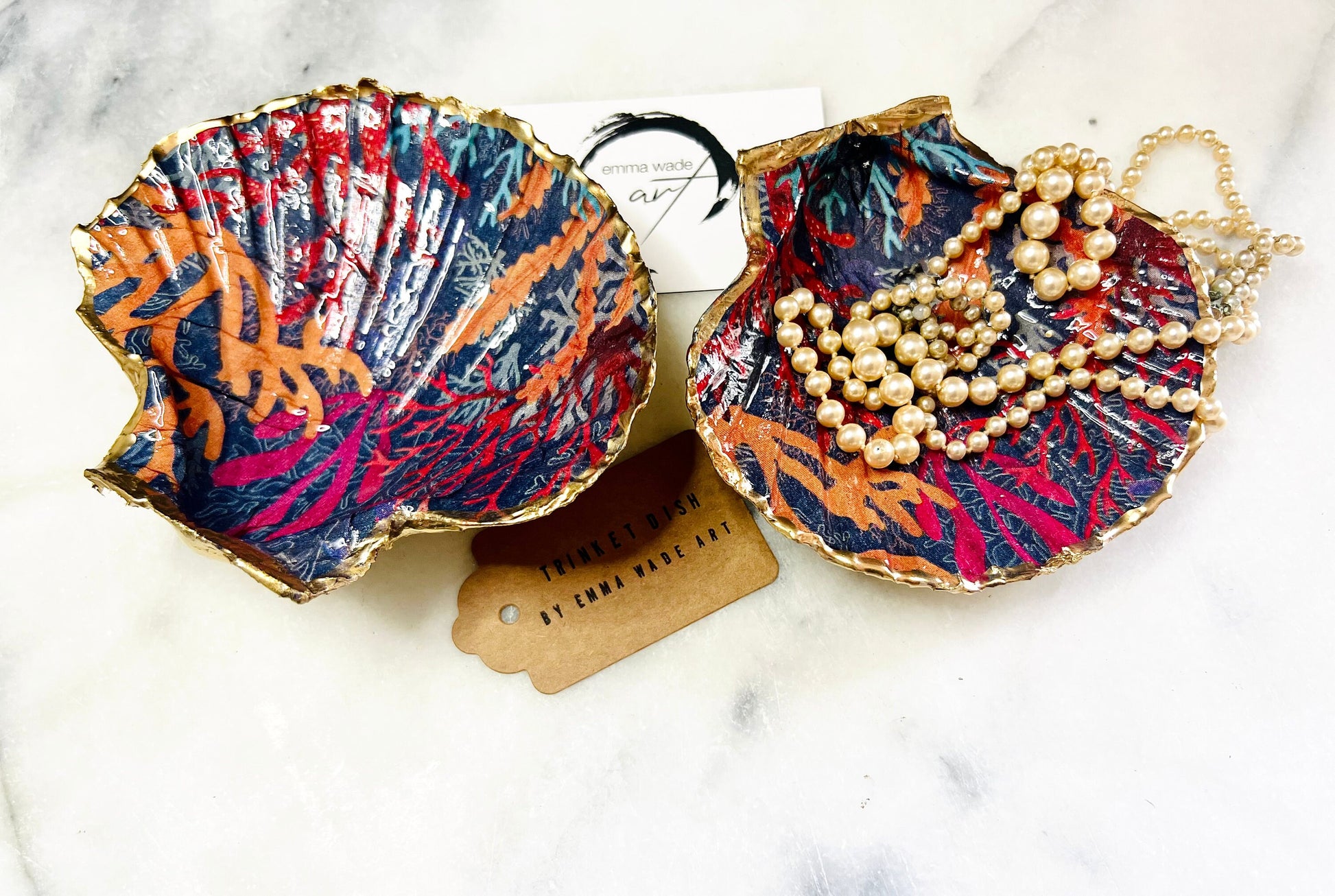 Handmade Dorset scallop shell trinket dish featuring vibrant coral reef and seaweed design in red orange turquoise and navy blue tones, finished with hand gilded gold leaf edging and glossy resin, luxury coastal jewellery holder and ocean inspired decor