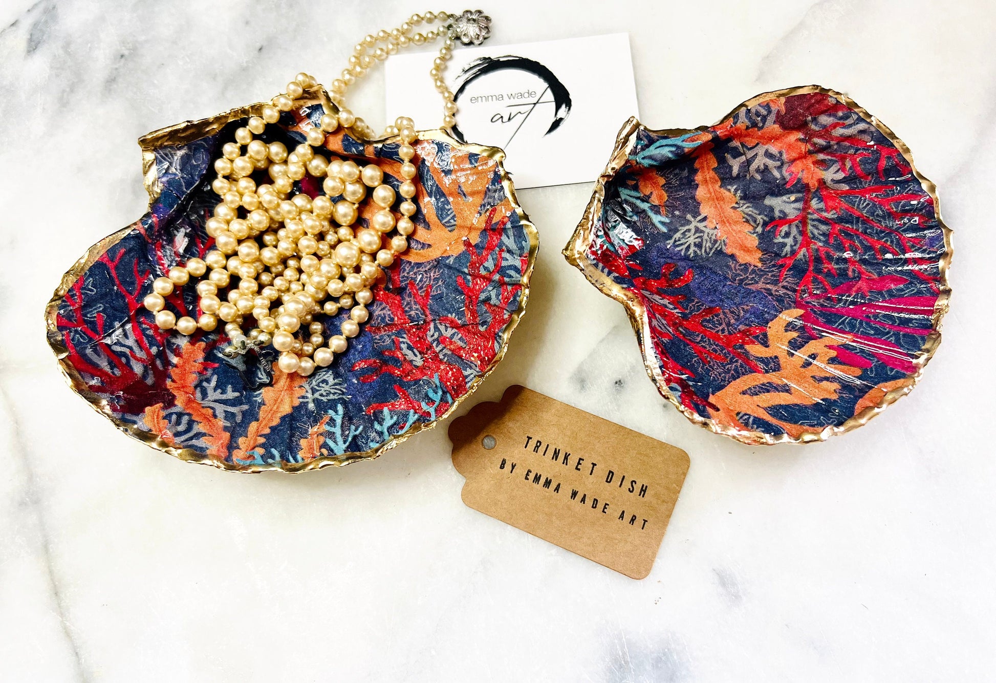 Handmade Dorset scallop shell trinket dish featuring vibrant coral reef and seaweed design in red orange turquoise and navy blue tones, finished with hand gilded gold leaf edging and glossy resin, luxury coastal jewellery holder and ocean inspired decor