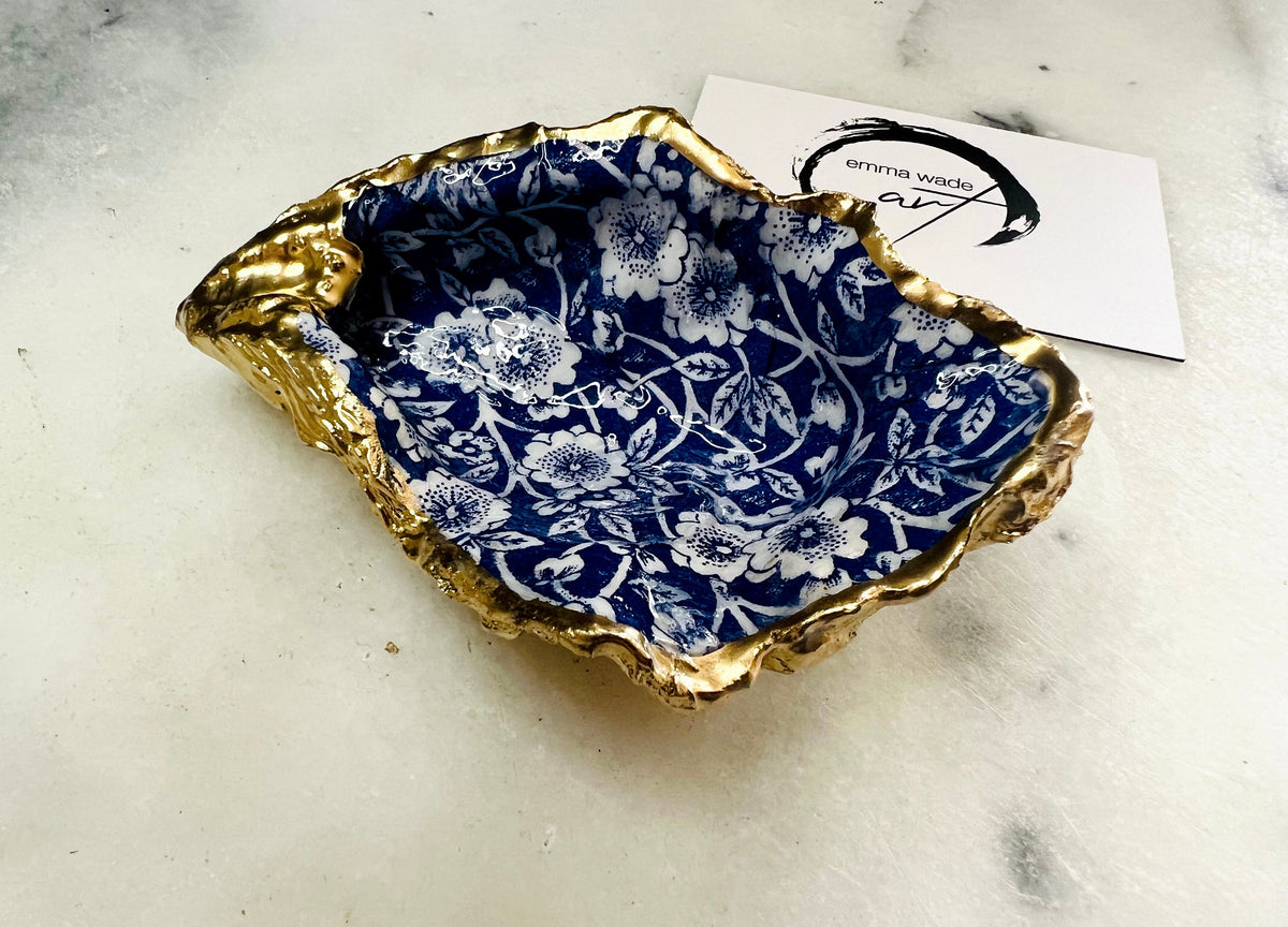 navy blue and white floral oyster shell dish, Dorset oyster shell jewellery holder, handmade coastal trinket dish UK, gold leaf gilded oyster shell ornament, eco friendly oyster shell vanity tray, unique handmade oyster shell cufflink or tie pin dish, navy floral oyster shell salt and pepper pinch pot, oyster shell spoon rest or sugar dish, floral oyster shell coastal bathroom accessory, sustainable Dorset oyster shell art, handmade oyster shell wedding or anniversary gift UK
